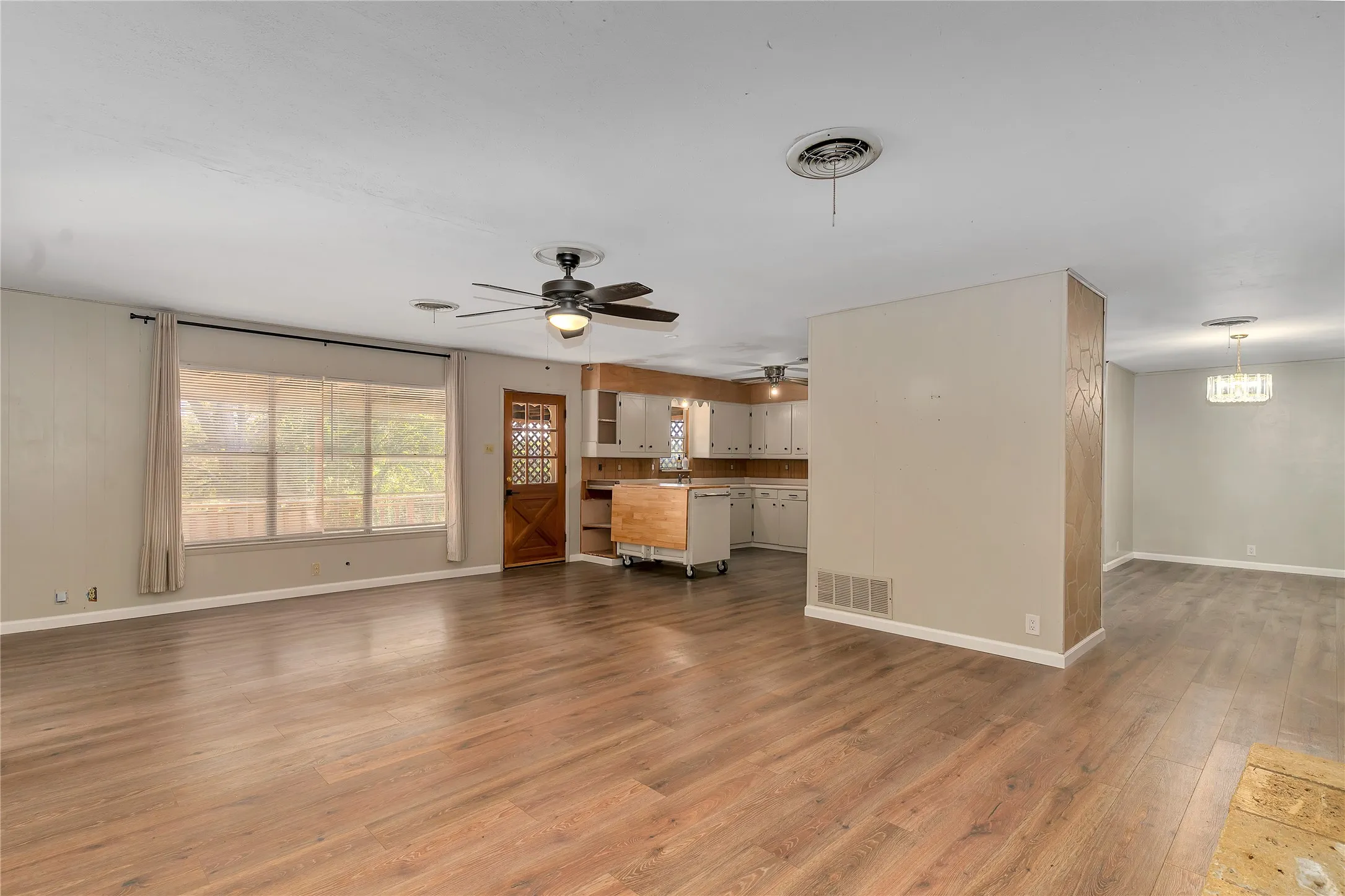 Unfurnished living room with light wood finished floors and a ceiling fan