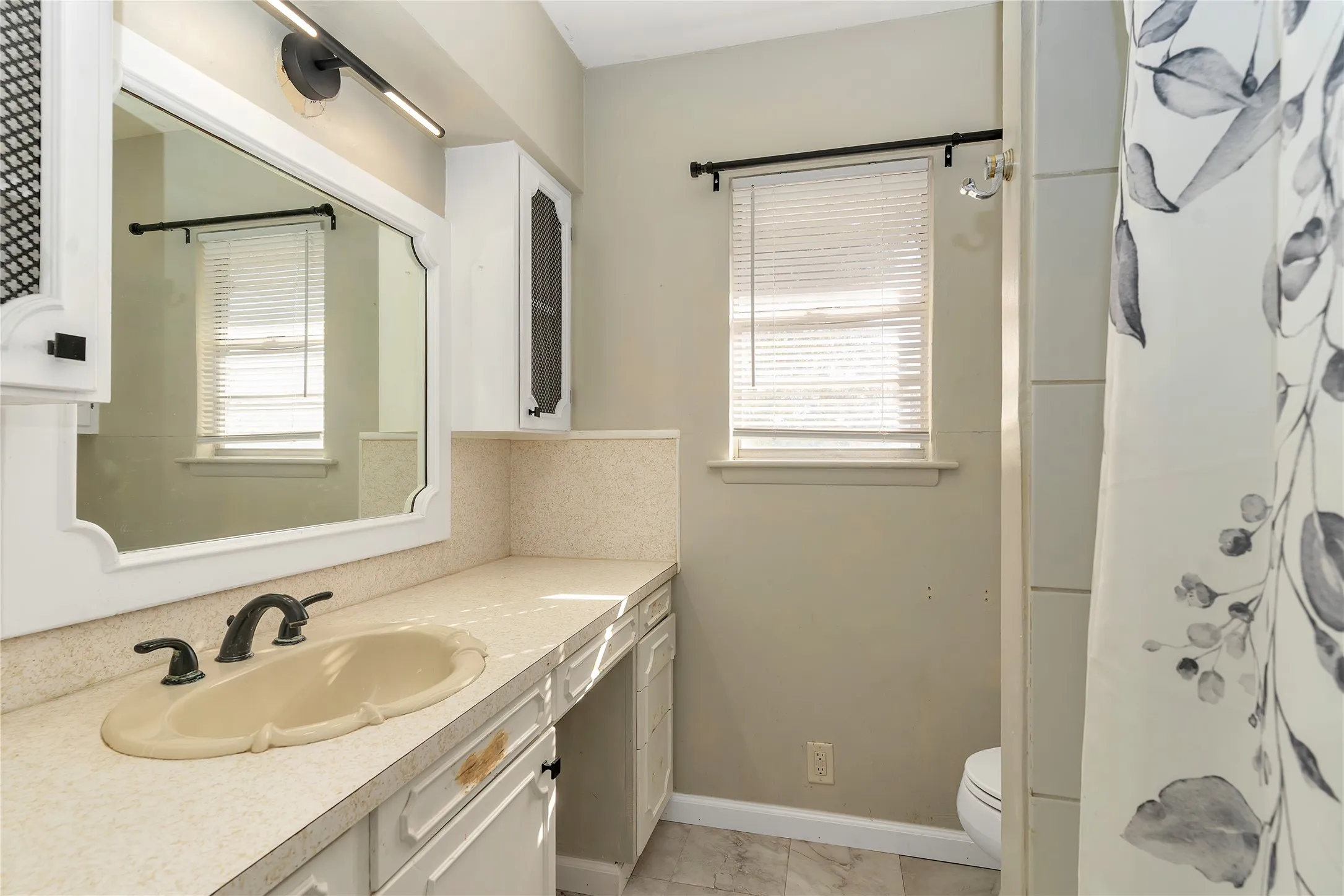 Full bath with vanity, plenty of natural light, and a shower