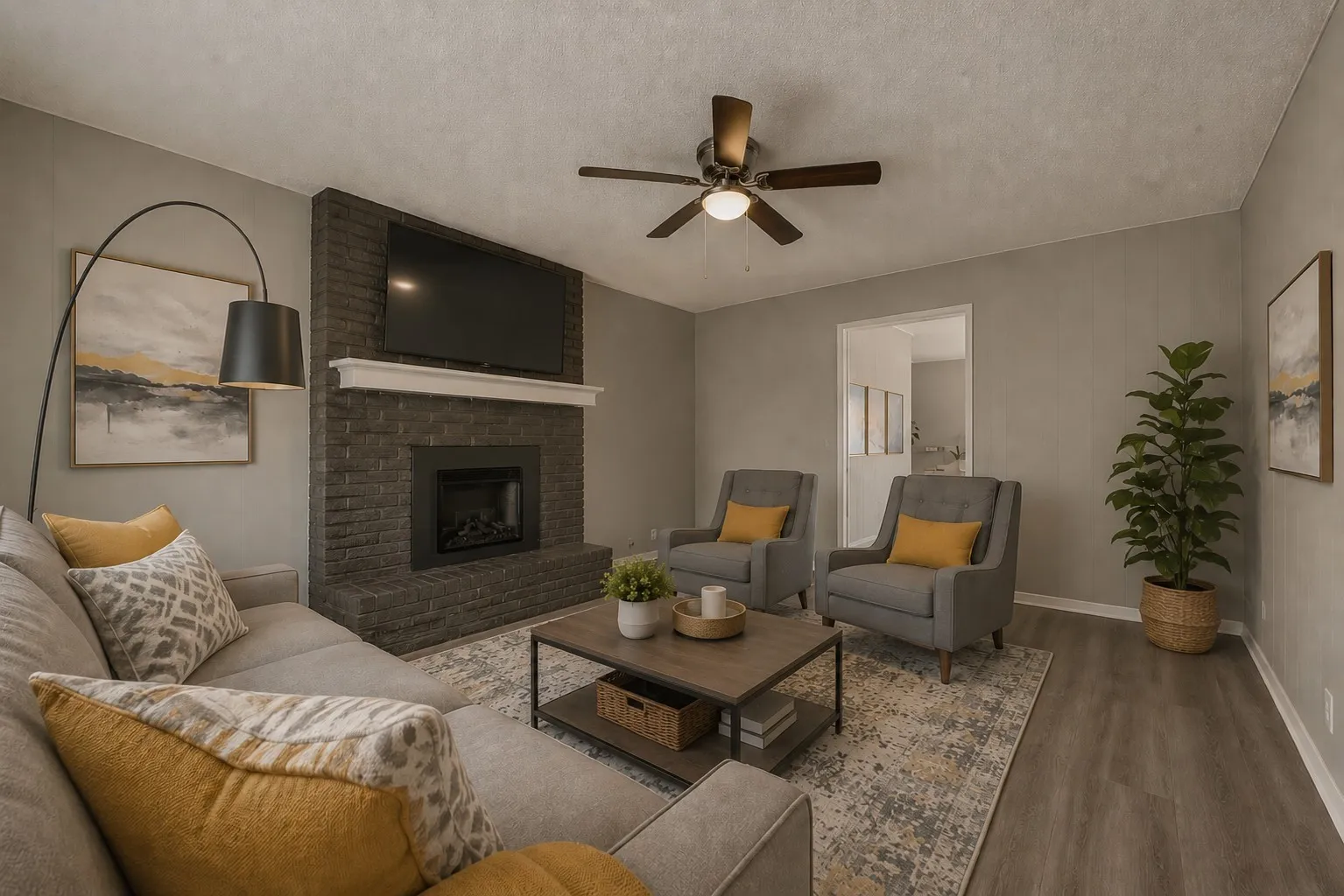 Living area featuring a dark brick fireplace with a white mantel, ceiling fan with integrated lighting, and wood-finish flooring