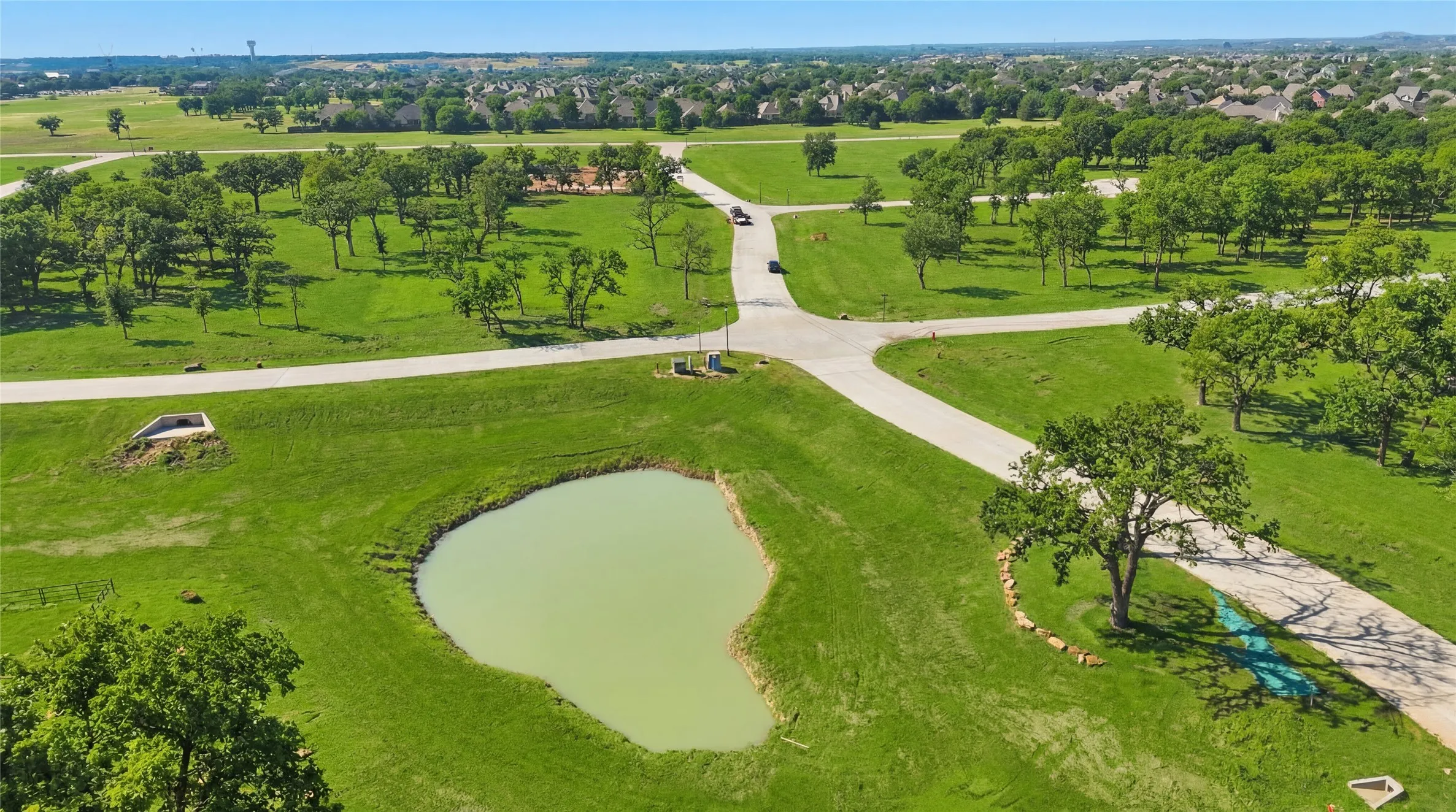 This is a photograph of the community and was captured in February. It has been digitally enhanced to emphasize the presence of leaves and grass.
