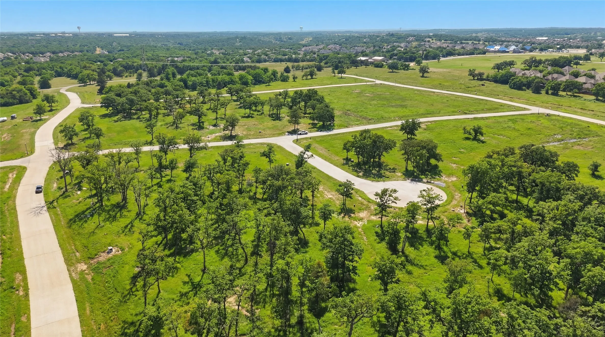 This is a photograph of the community and was captured in February. It has been digitally enhanced to emphasize the presence of leaves and grass.
