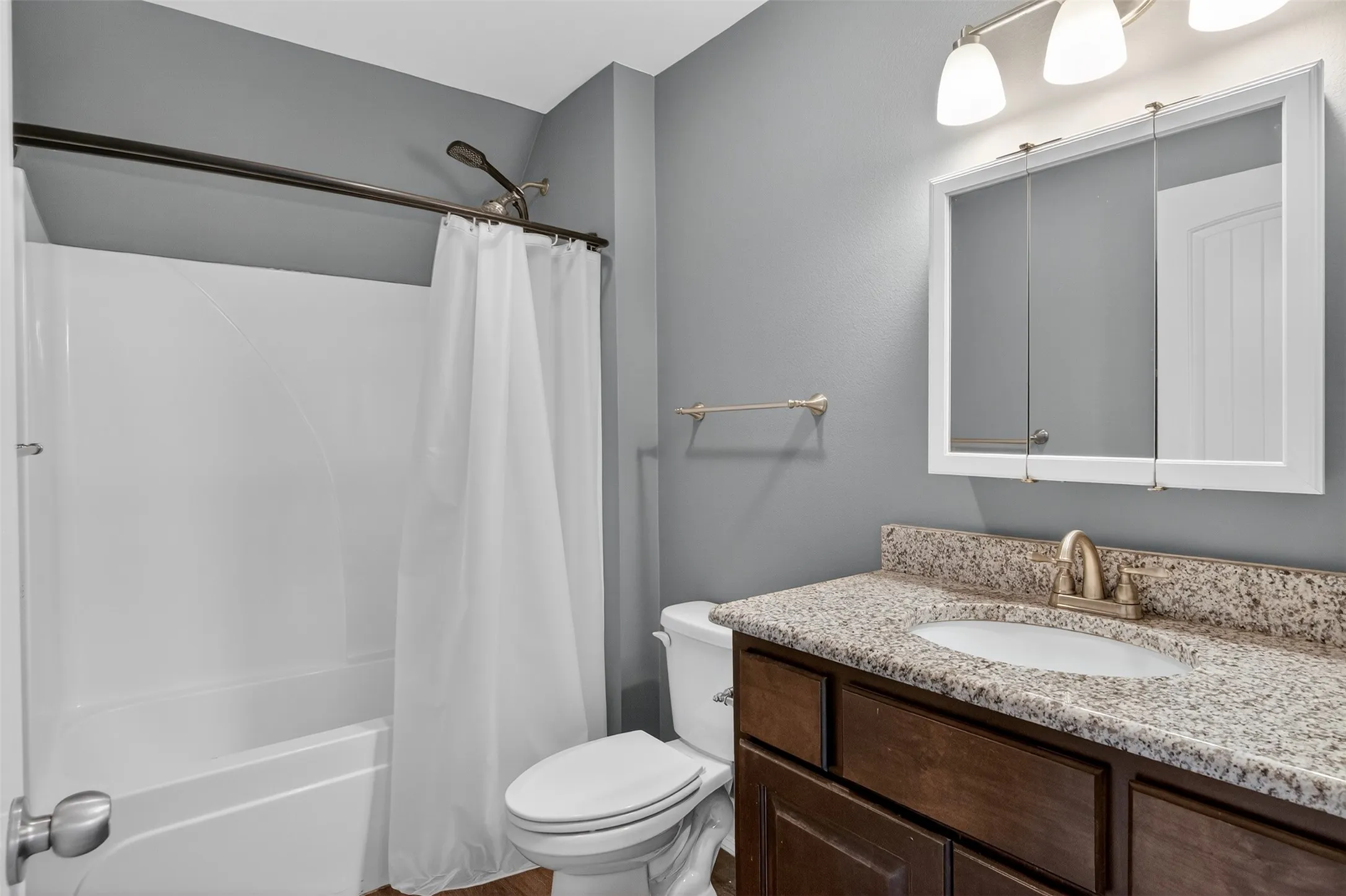 Bathroom with vanity and shower / bath combination with curtain