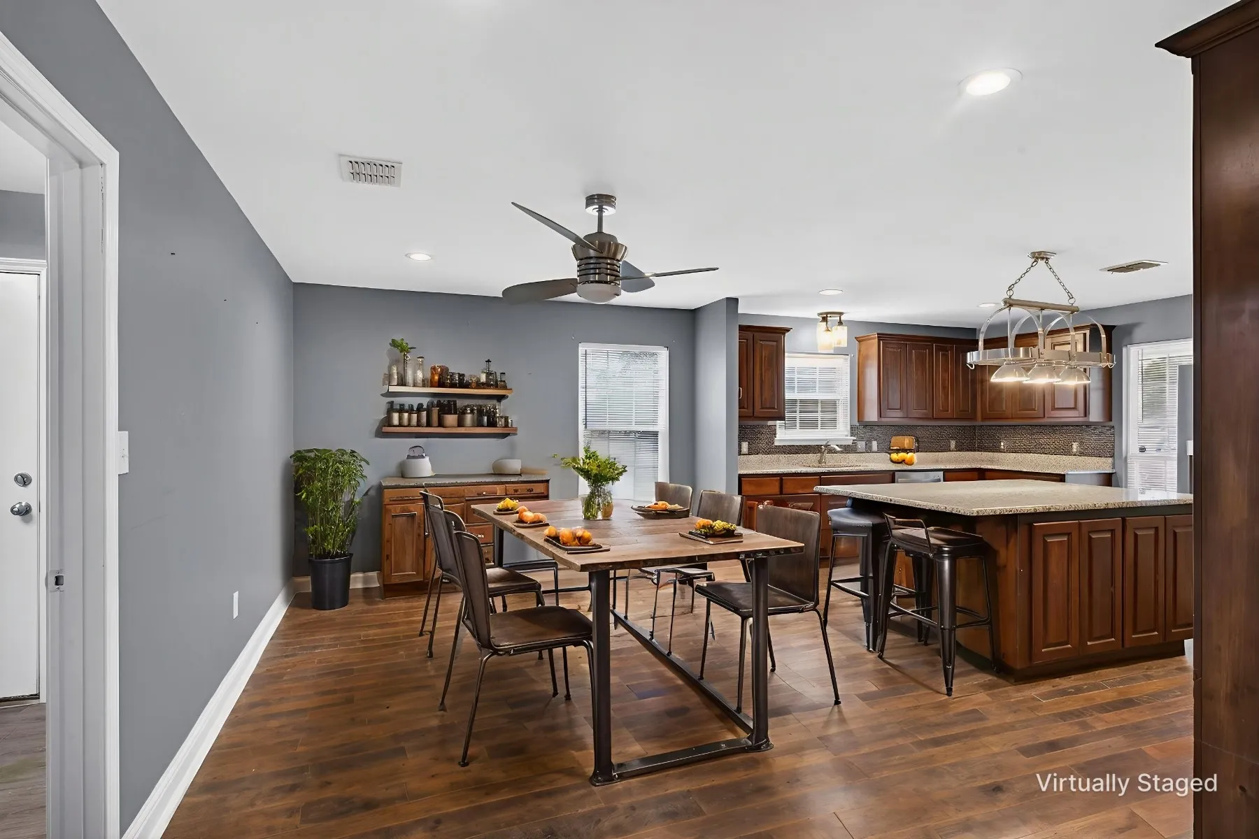 Dining space featuring dark wood finished floors, a ceiling fan, and recessed lighting