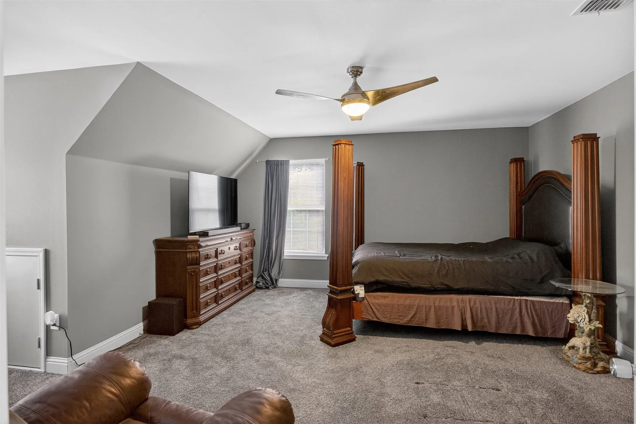 Bedroom featuring carpet, ceiling fan, and lofted ceiling
