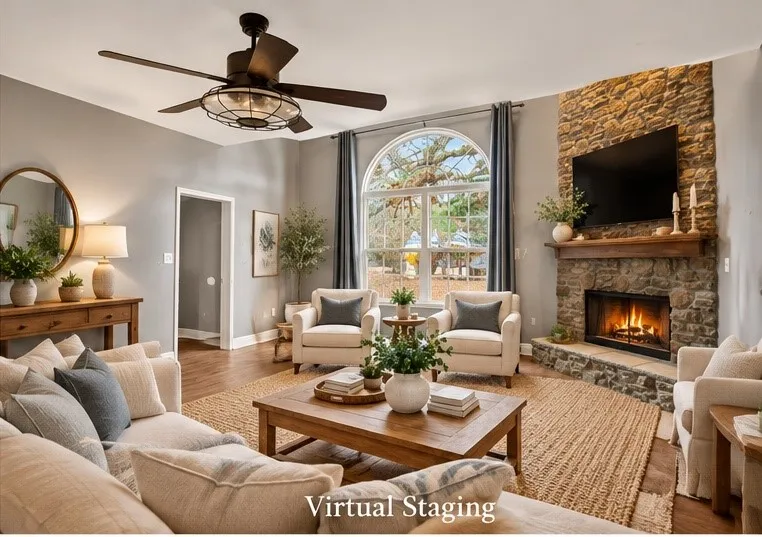 Stone-clad fireplace with a wood mantle, wood-finish flooring, arched window, and a ceiling fan with integrated lighting