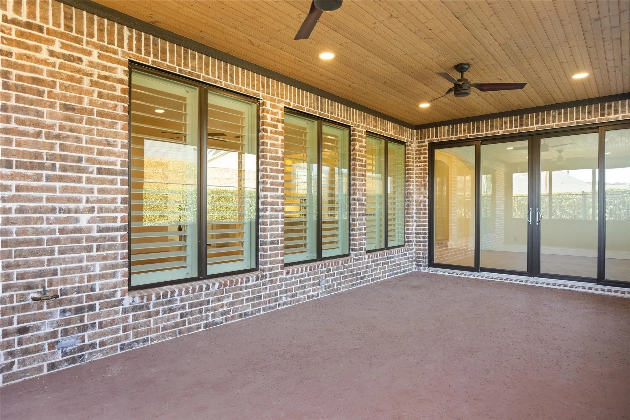 View of patio with a ceiling fan and french doors