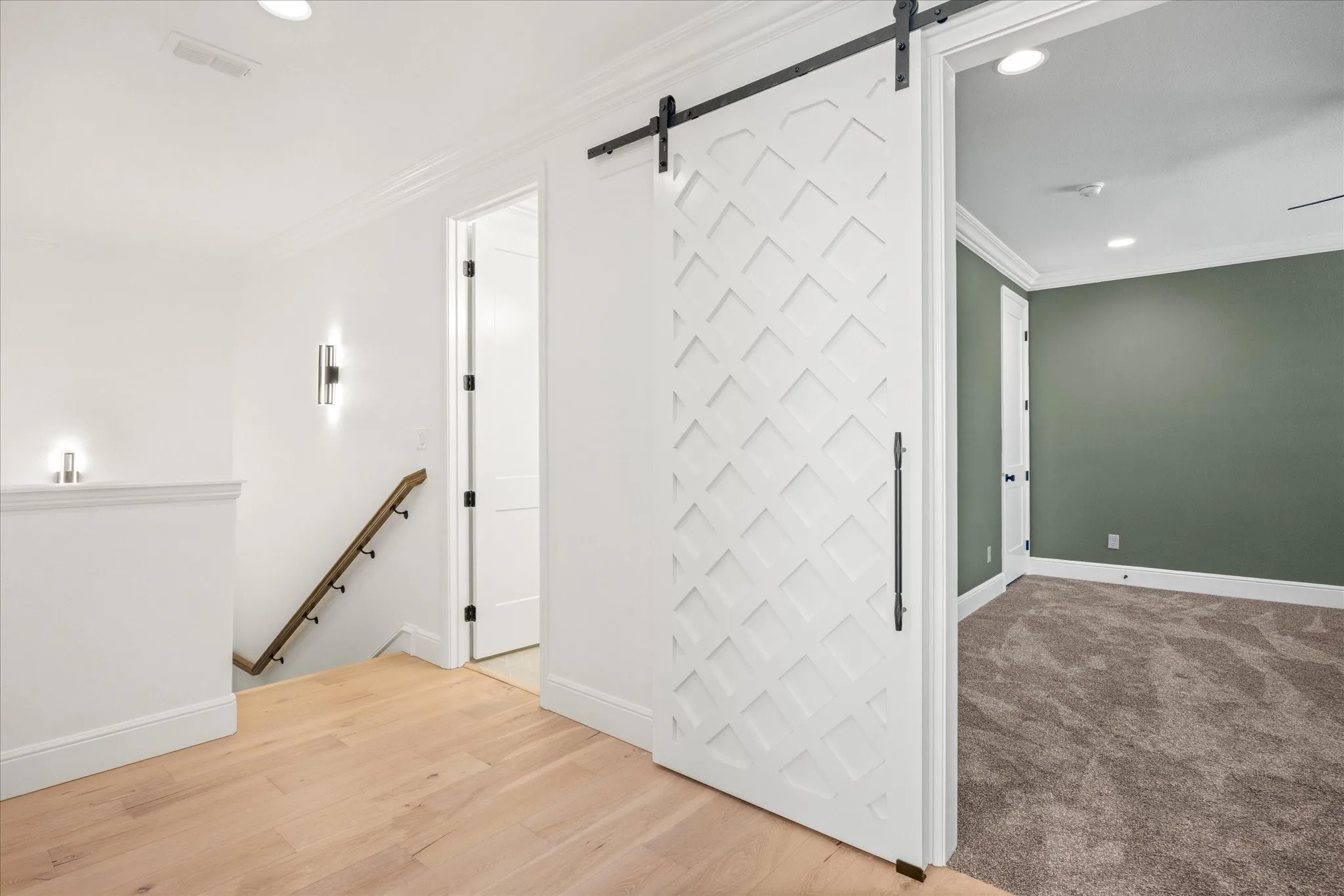 Spare room with recessed lighting, crown molding, and light wood-style floors