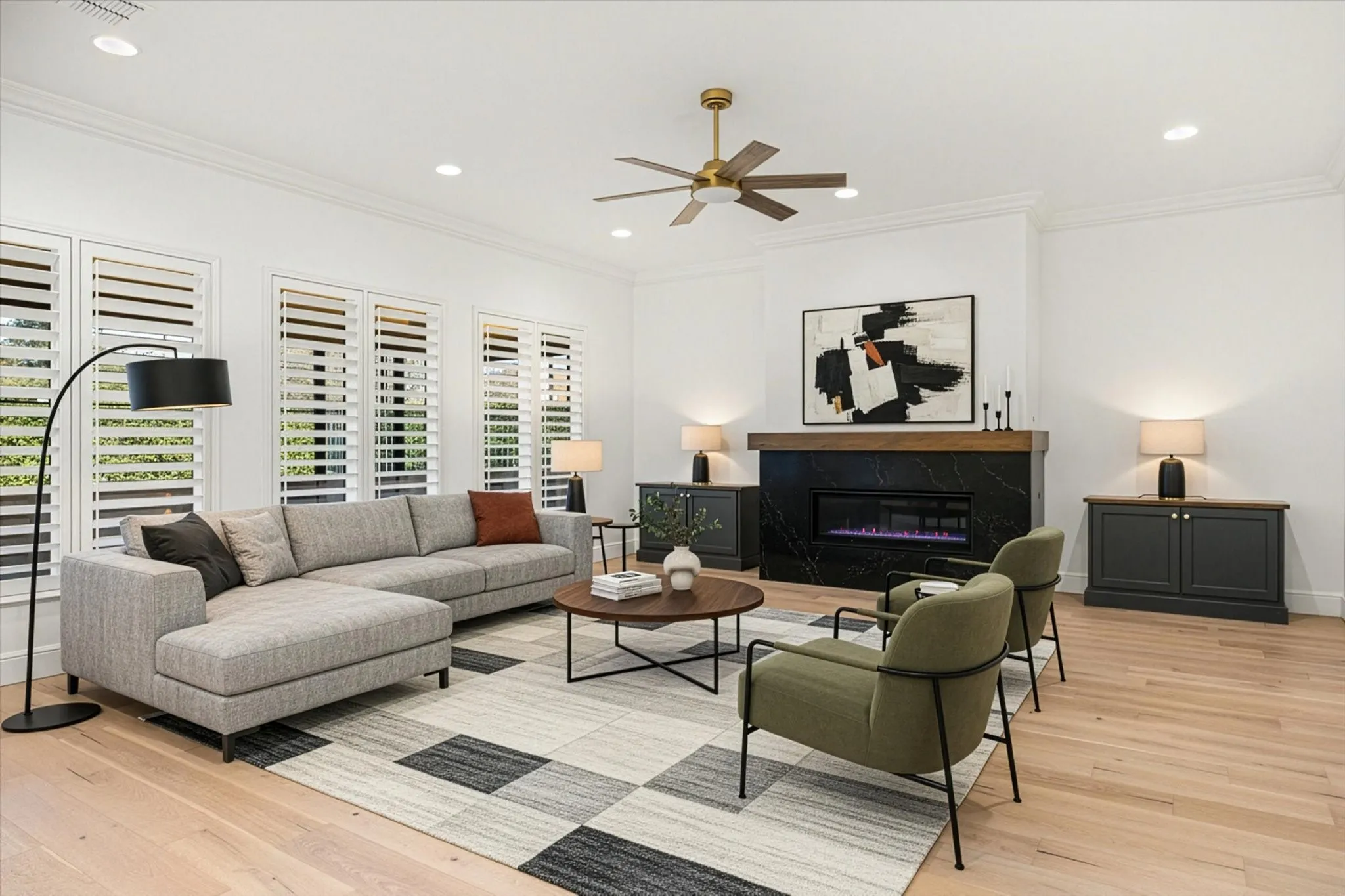 Living area with crown molding, a premium fireplace, light wood-style flooring, recessed lighting, and ceiling fan