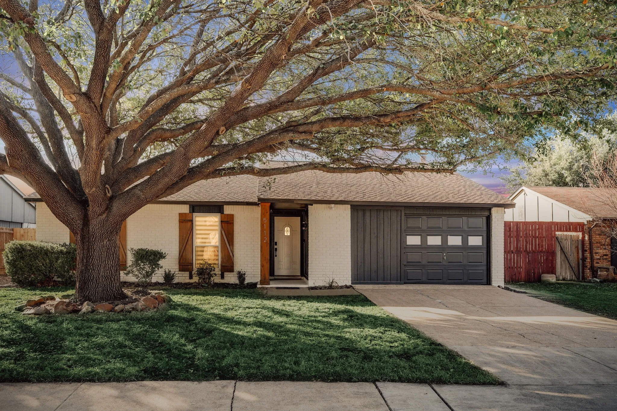 View of front of home featuring a garage and a yard