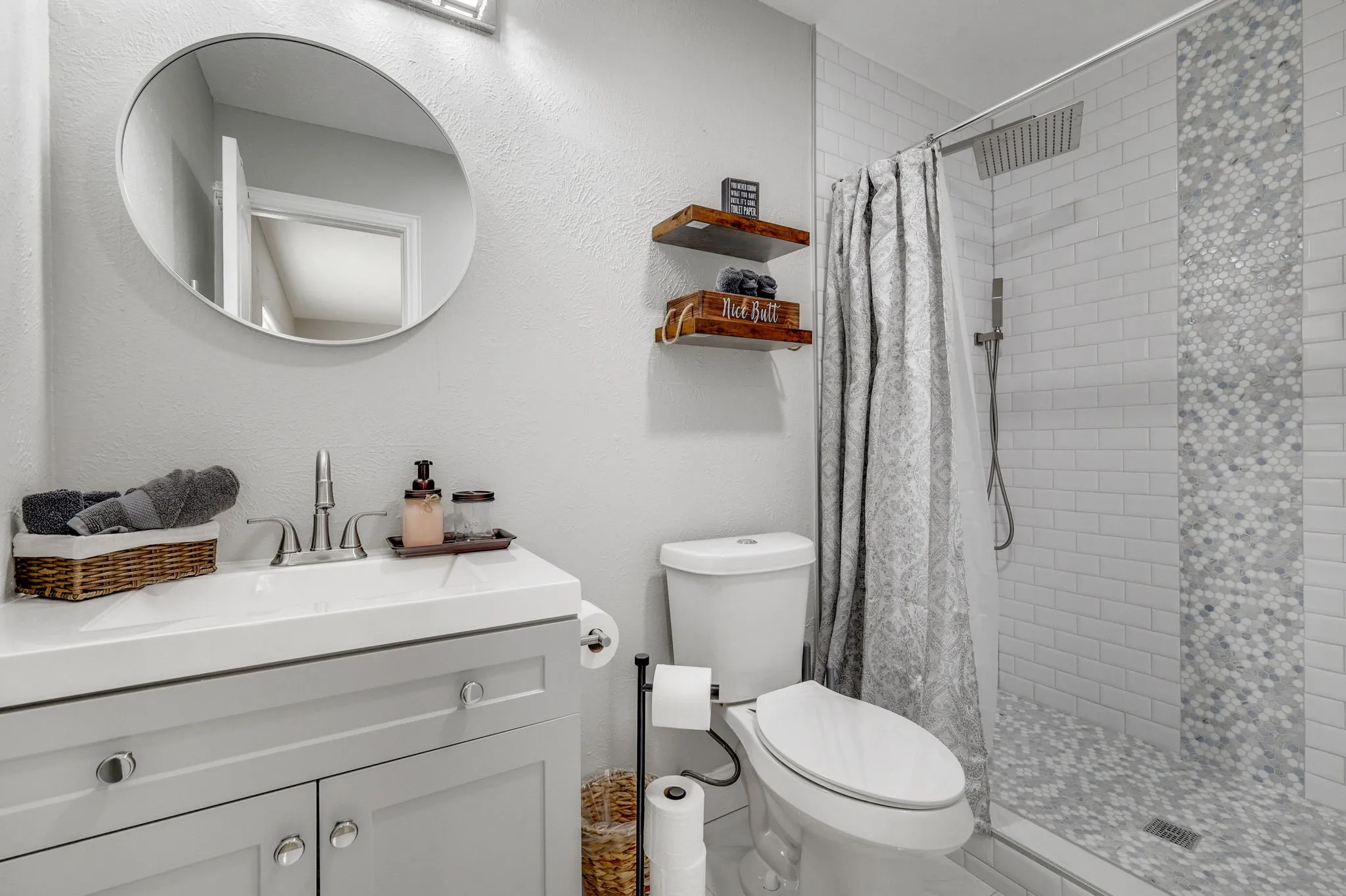 Bathroom with a shower with curtain, vanity, and toilet