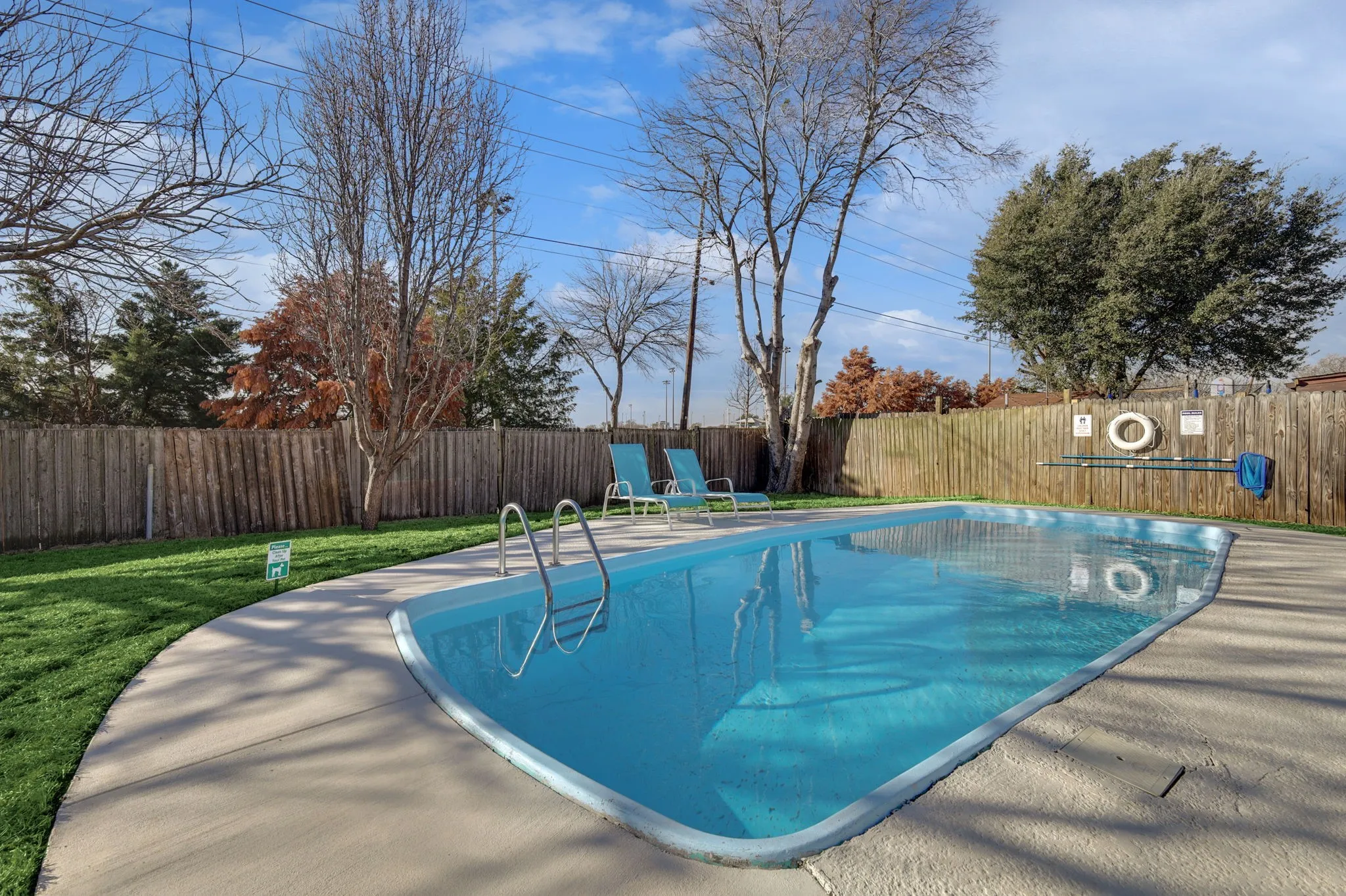 View of swimming pool featuring a lawn