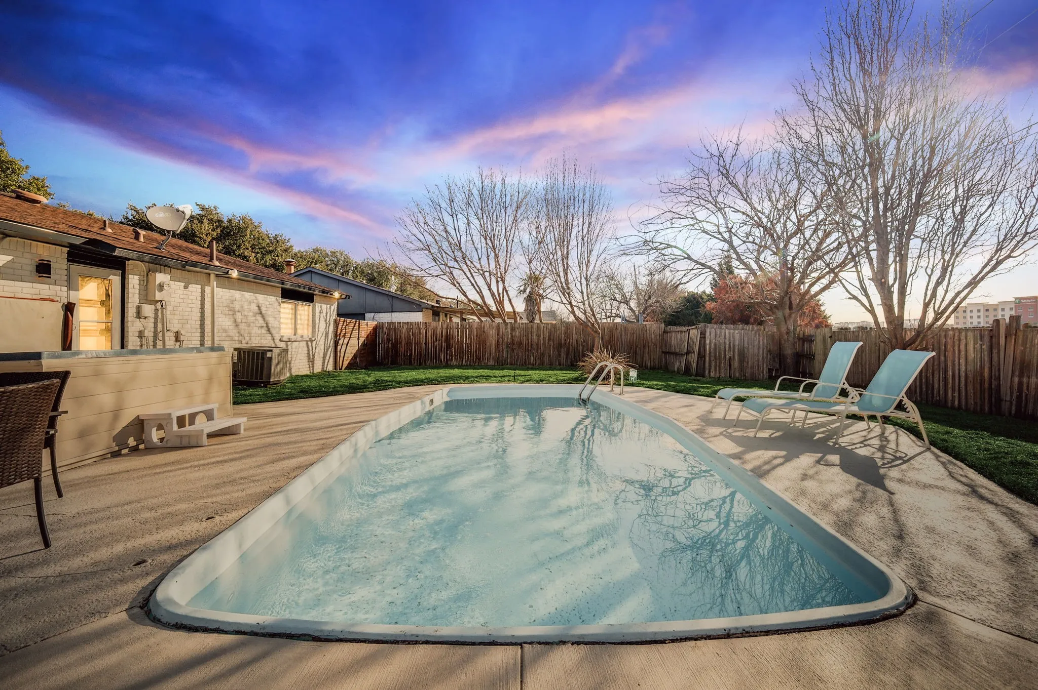 Pool at dusk with central AC unit