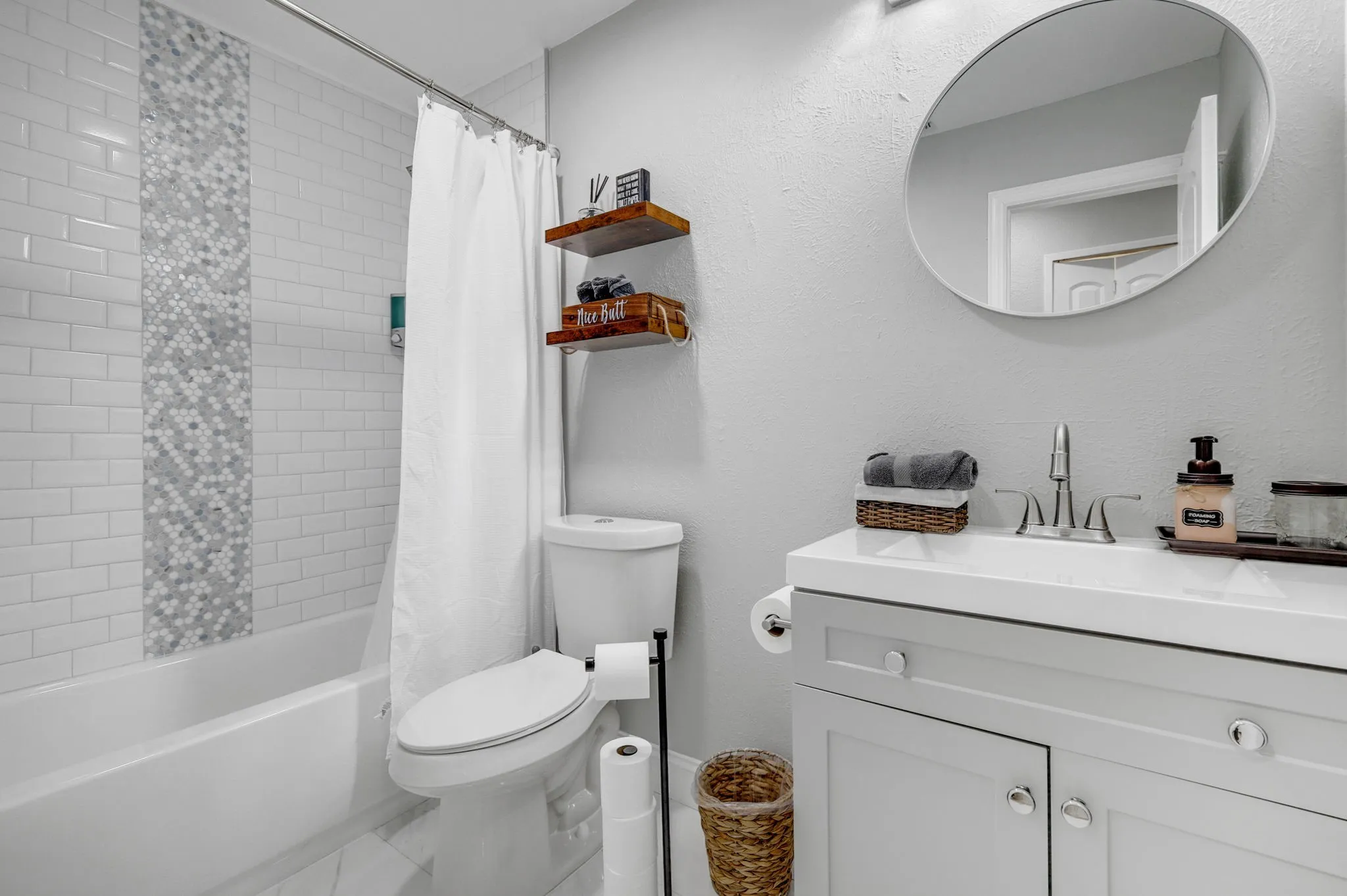 Full bathroom with vanity, toilet, and shower / bath combo with shower curtain