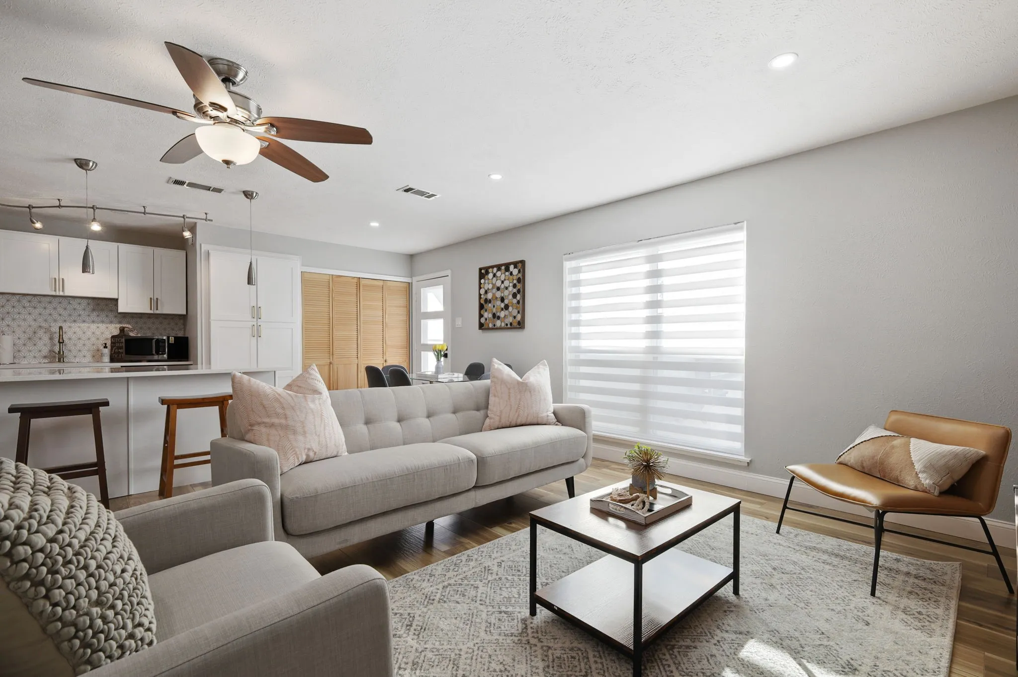 Living room featuring ceiling fan and dark hardwood / wood-style flooring