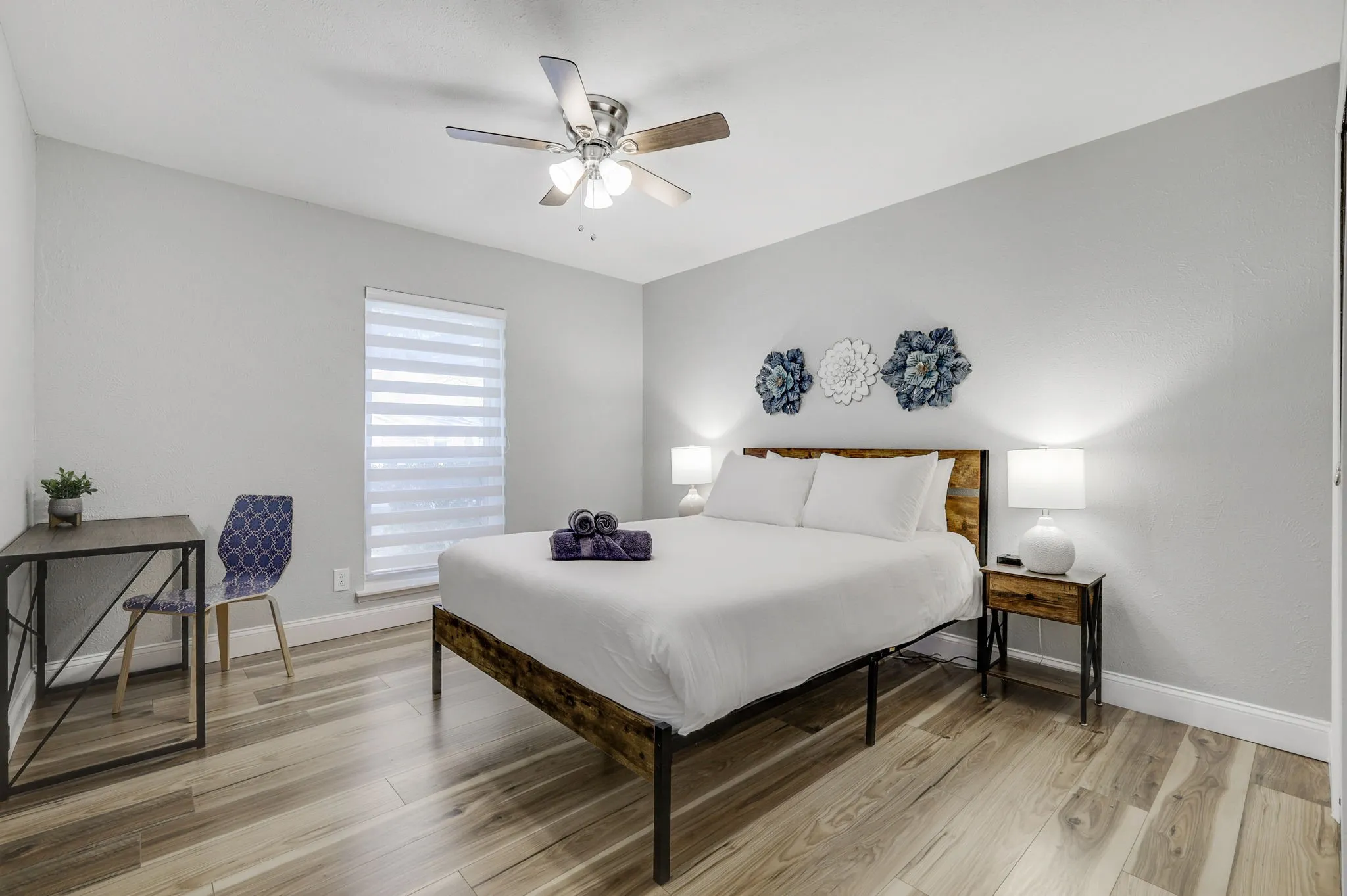 Bedroom featuring ceiling fan and light hardwood / wood-style flooring
