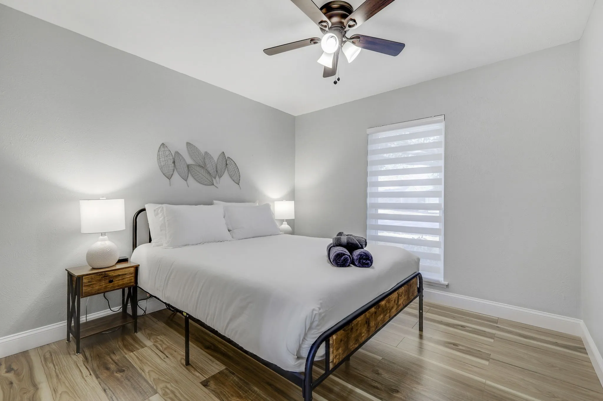 Bedroom with ceiling fan and wood-type flooring