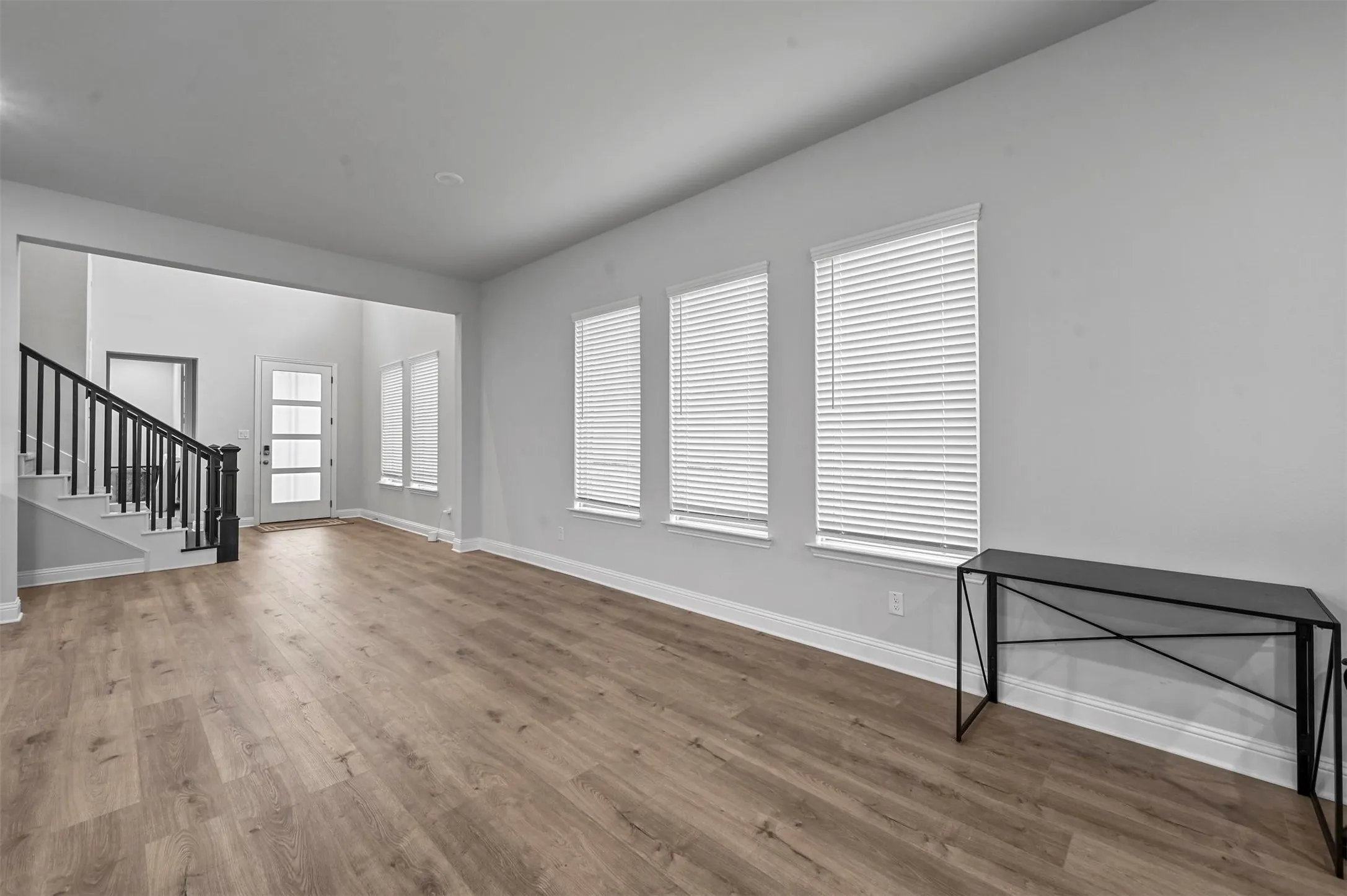  Living room with stairway and light wood floors