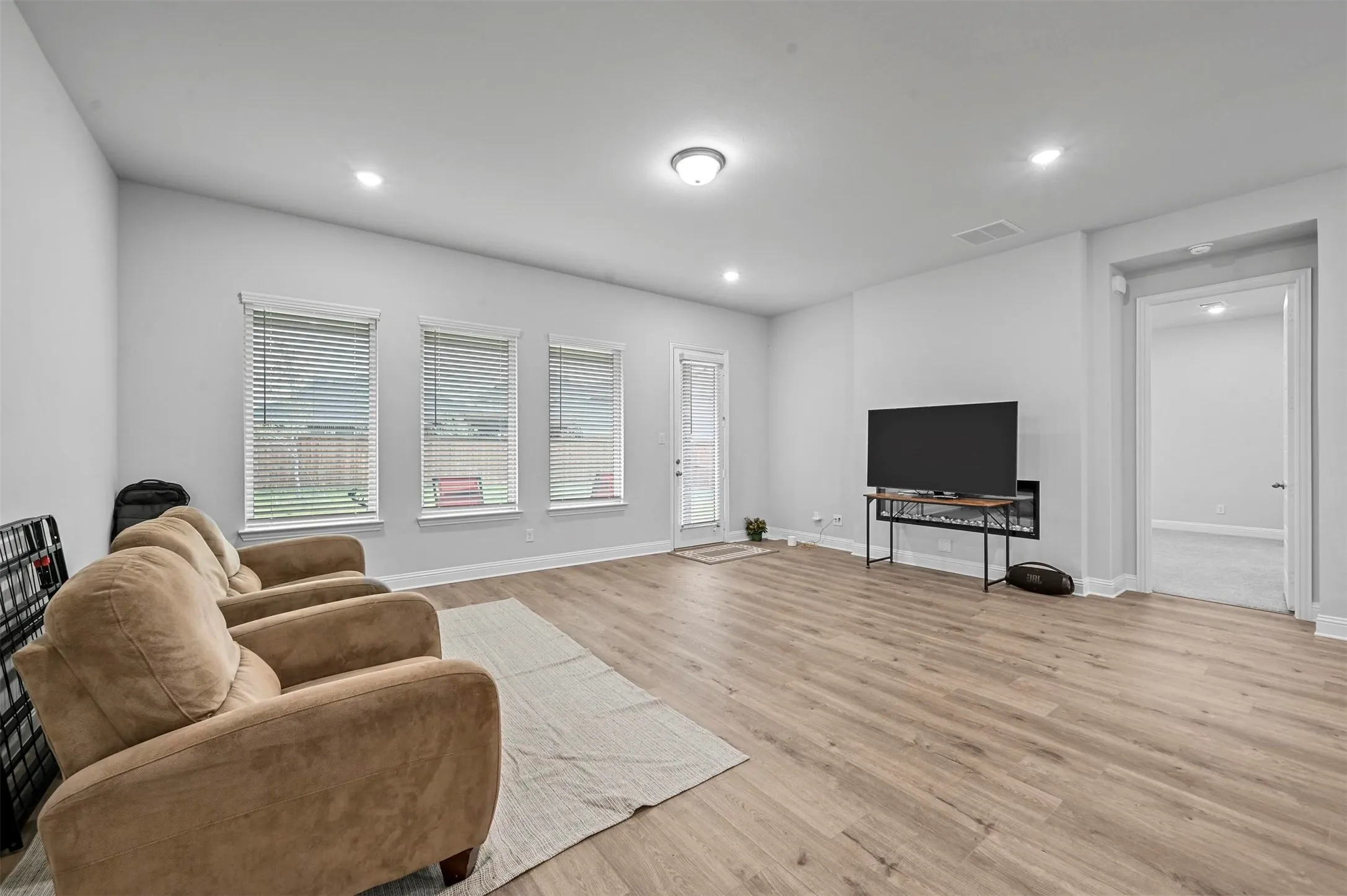 Living room featuring light wood finished floors and recessed lighting