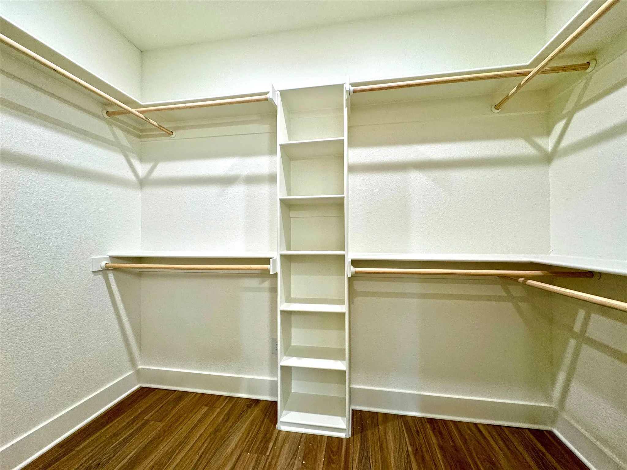 Walk in closet featuring dark wood-style flooring