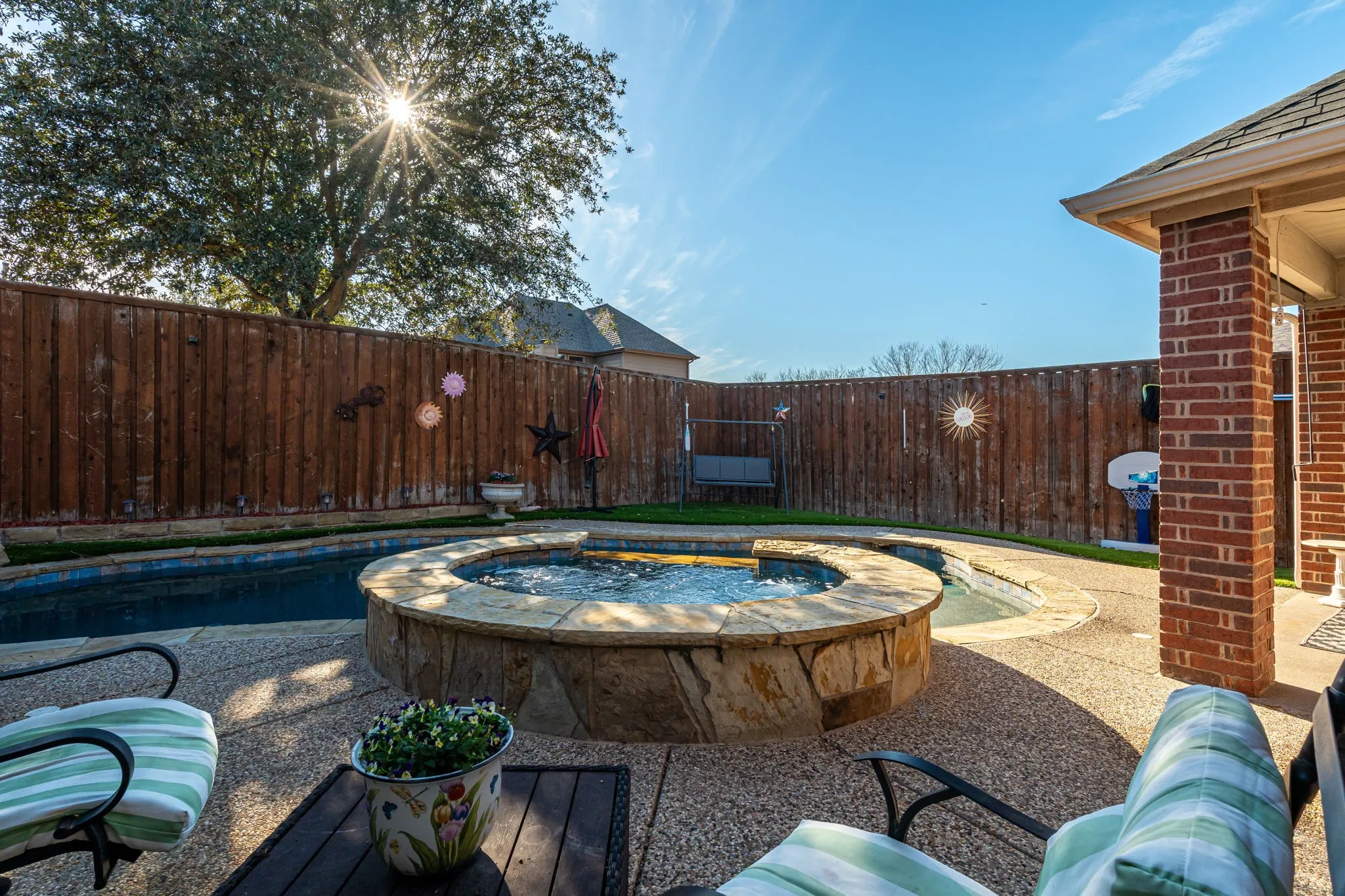 Relaxing pool / spa with a fenced backyard and a patio