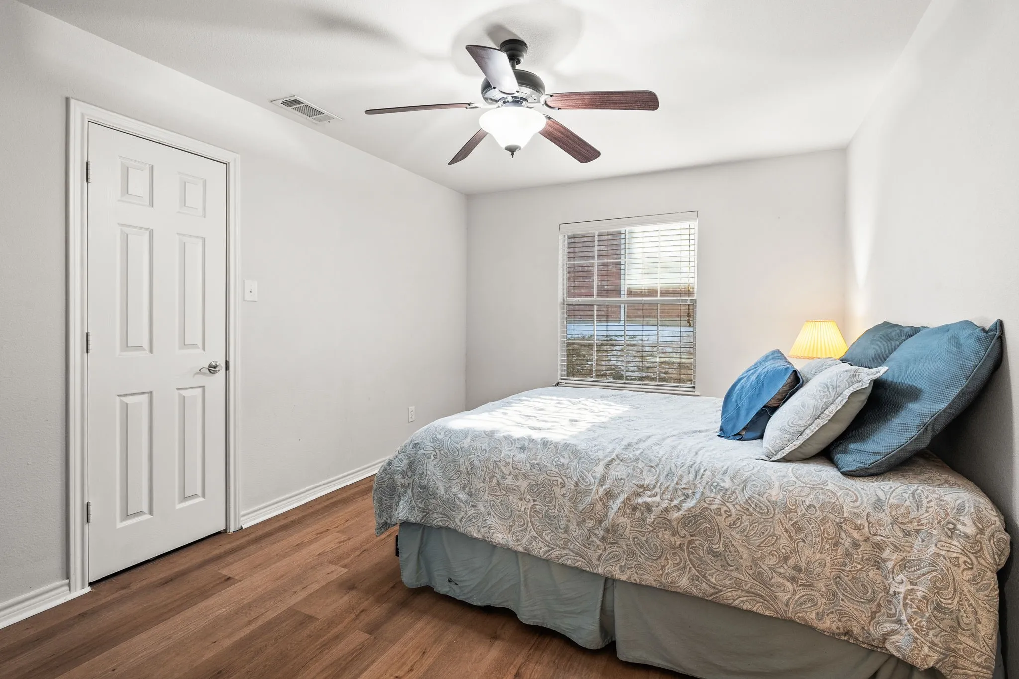 Bedroom featuring dark wood-style flooring and a ceiling fan