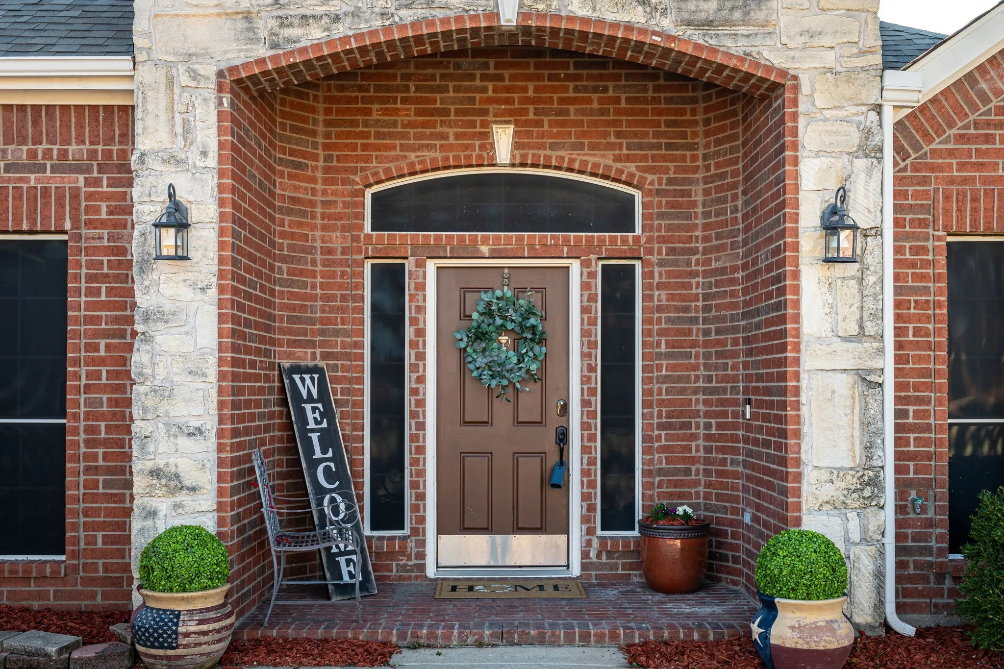 Entrance to property with brick siding and roof with shingles