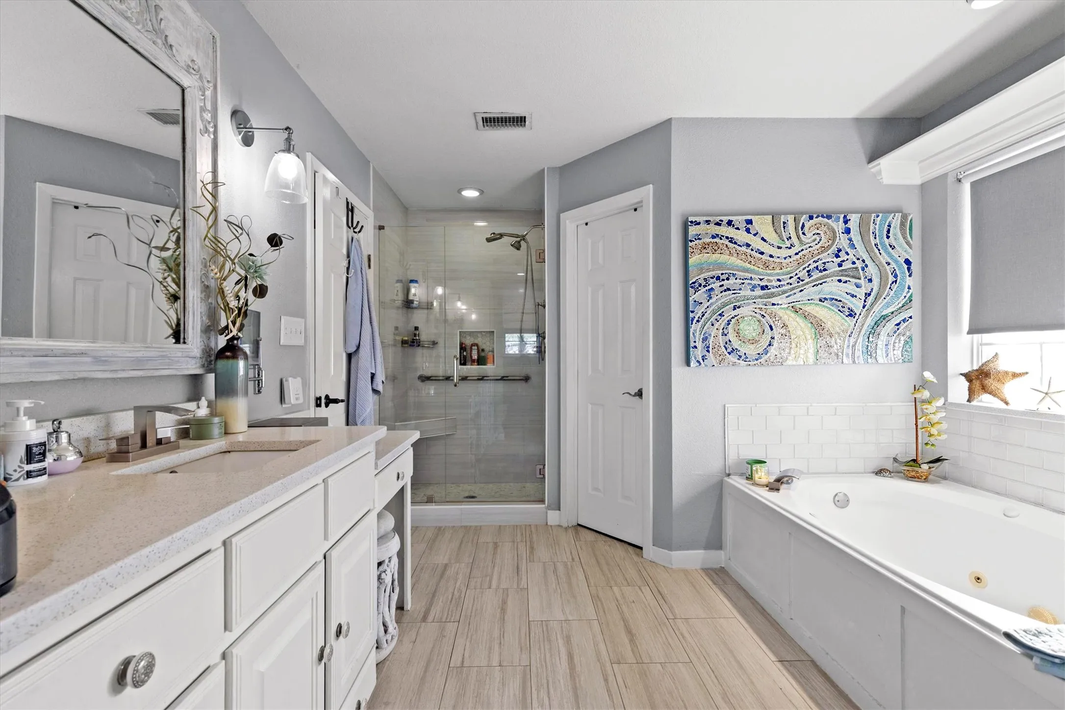 PRIMARY BATH...Tile Floor, Single Vanity W/Dressing Table, Large Tub, Tile Shower