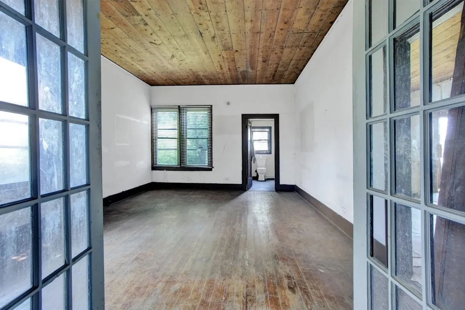 Unfurnished room featuring wood-type flooring and wooden ceiling