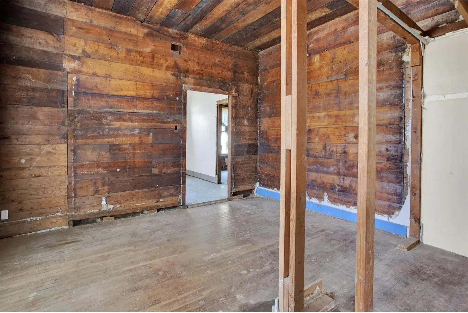 Spare room with wood walls, wood-type flooring, and wood ceiling