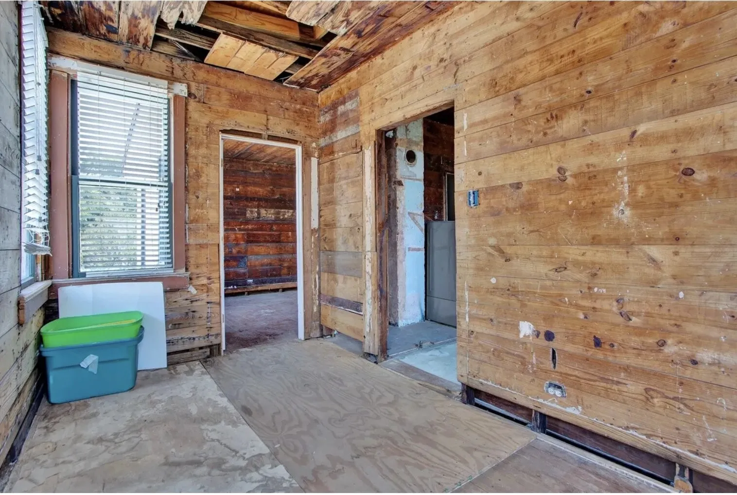 Spare room featuring wood walls