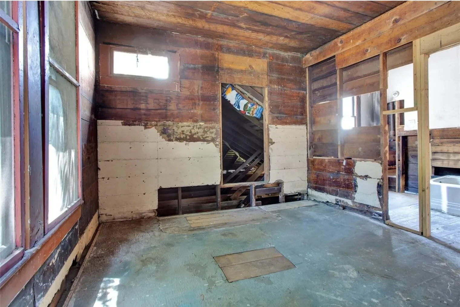 Spare room featuring wood ceiling and unfinished concrete floors