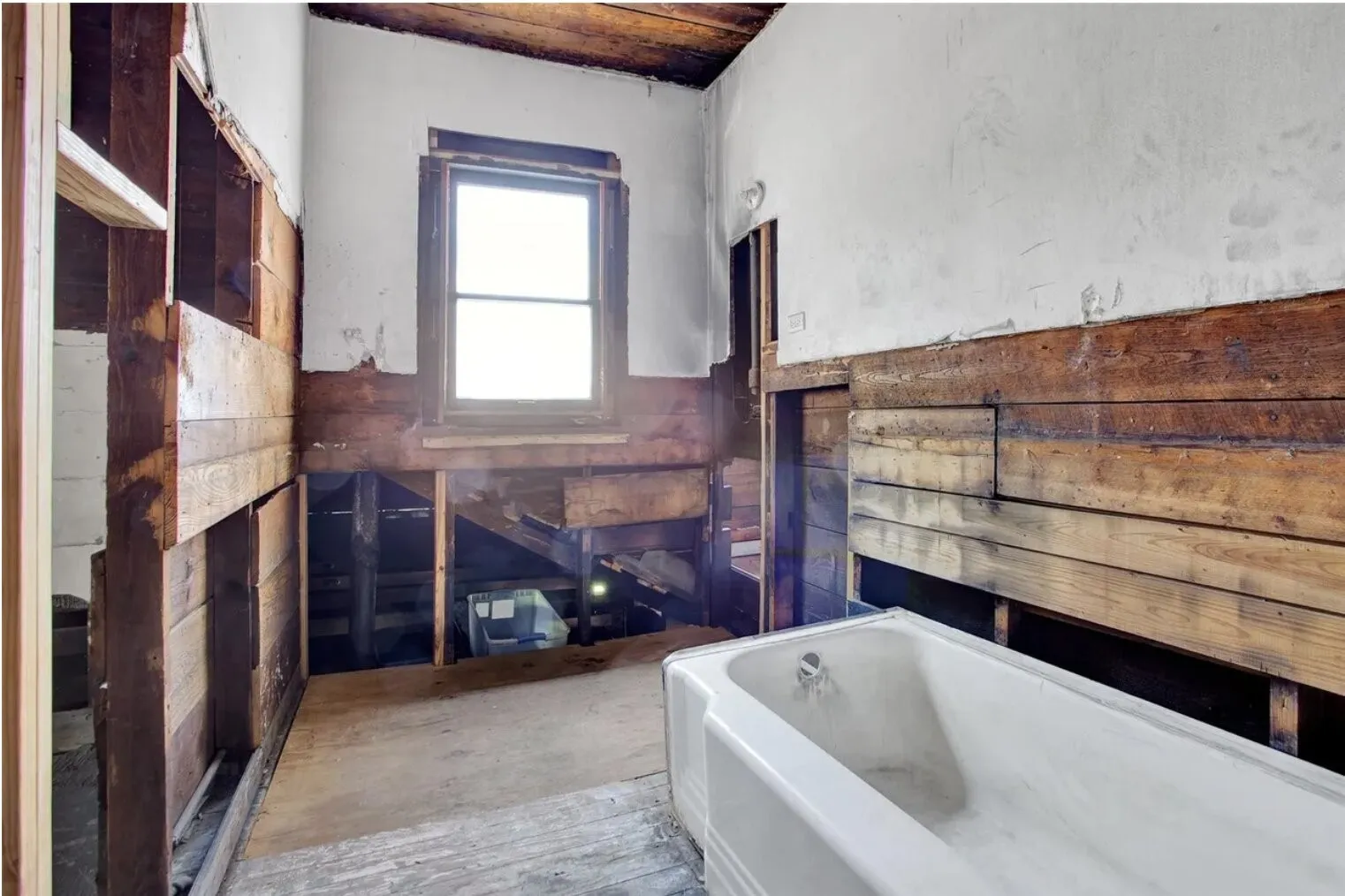 Bathroom with wooden ceiling and a tub to relax in