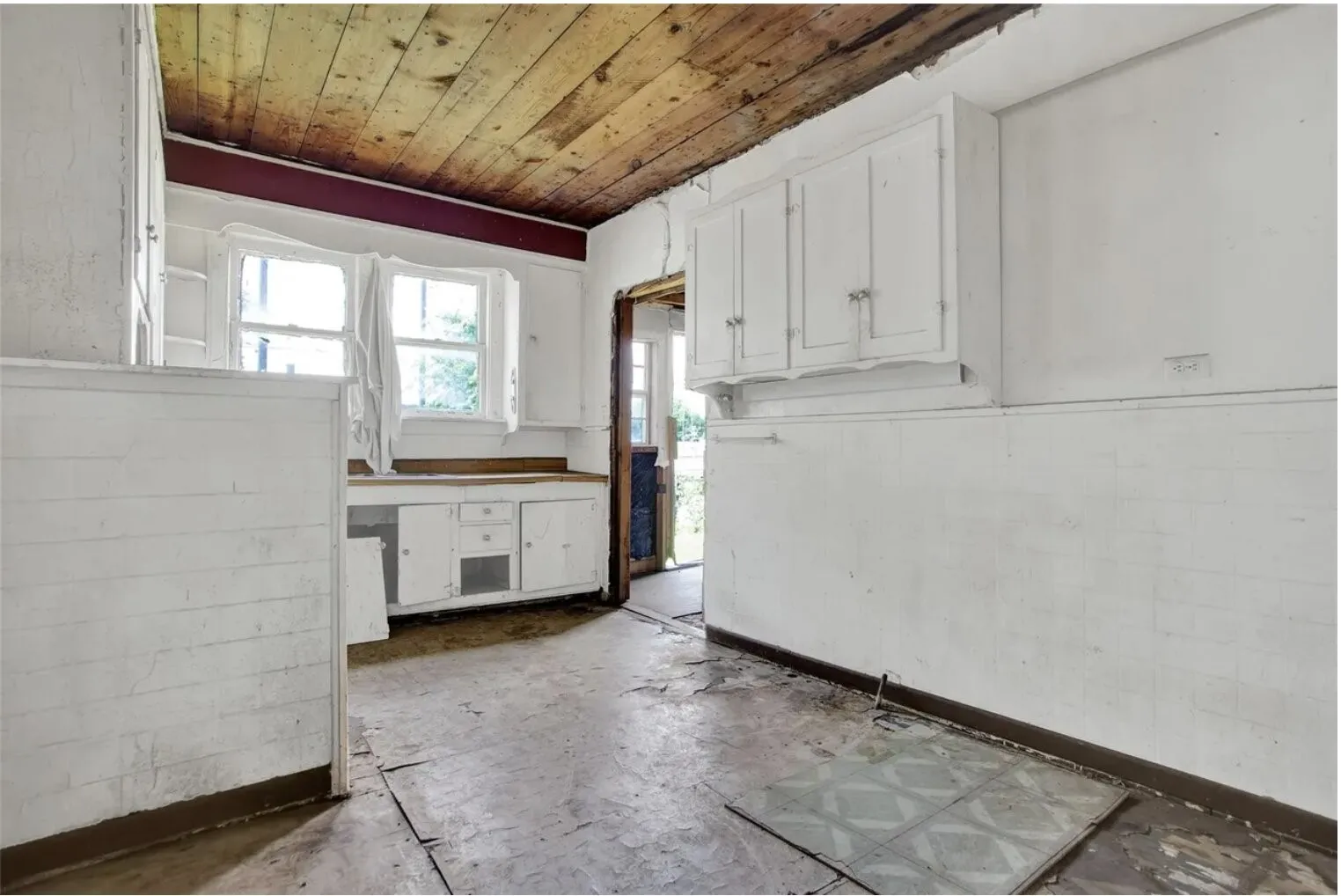 Kitchen featuring white cabinetry and wood ceiling