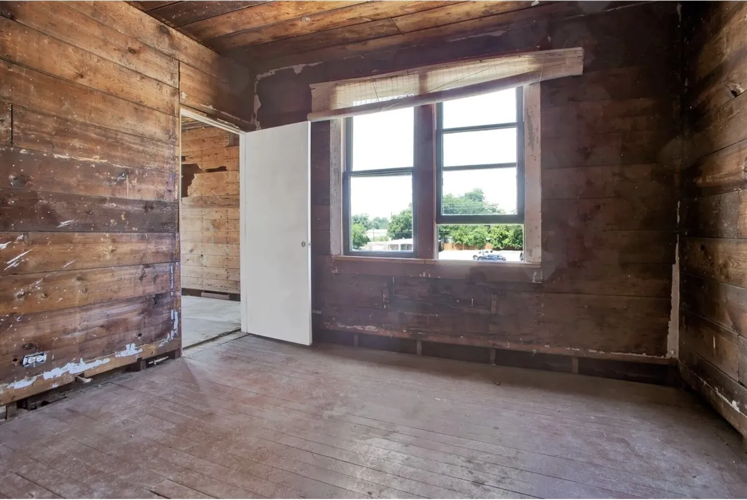 Spare room featuring wooden walls, wood-type flooring, and wooden ceiling