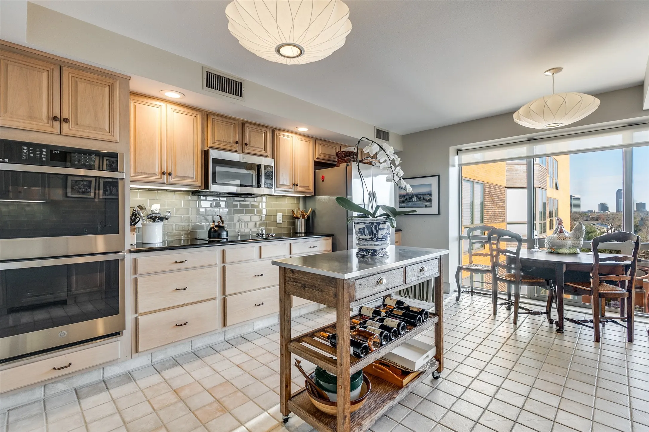 Kitchen with breakfast area also faces south with spectacular view of downtown.