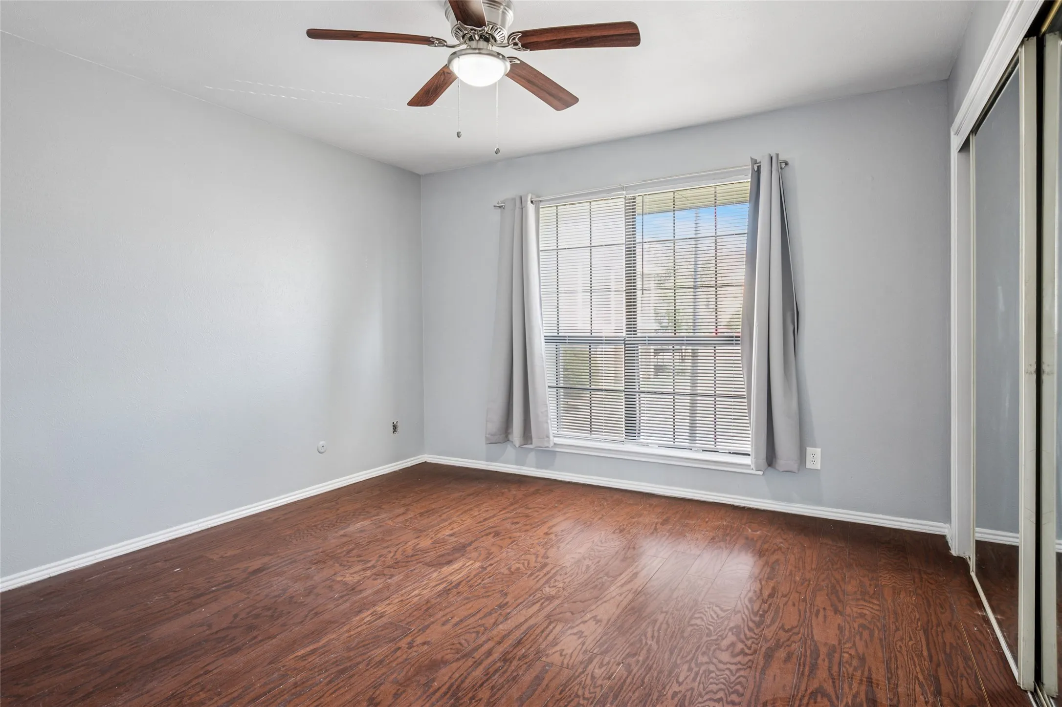 Primary with large window and ceiling fan