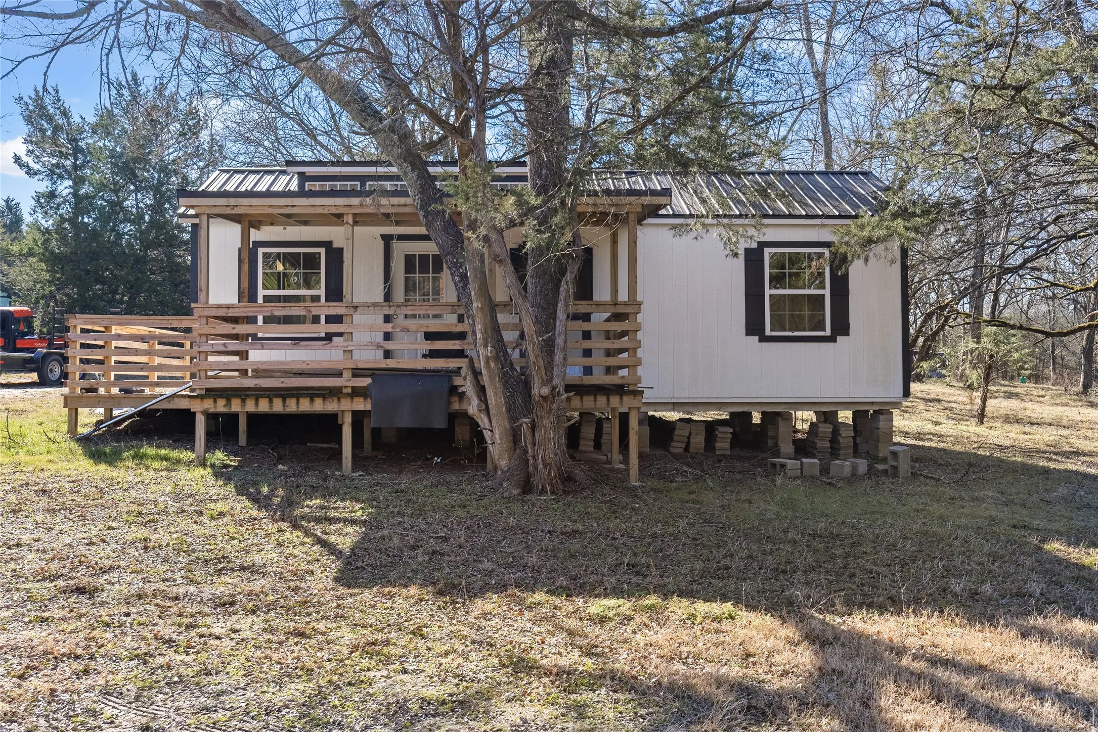View of front facade with a metal roof and a deck