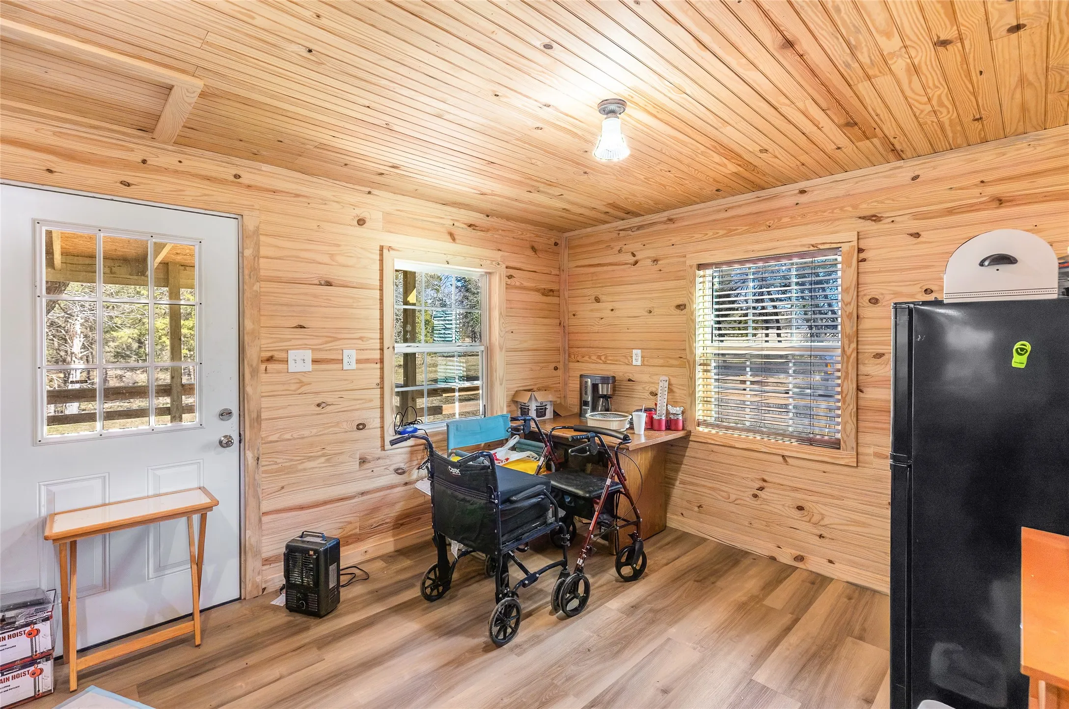 Home office featuring wood walls, wood finished floors, and wood ceiling
