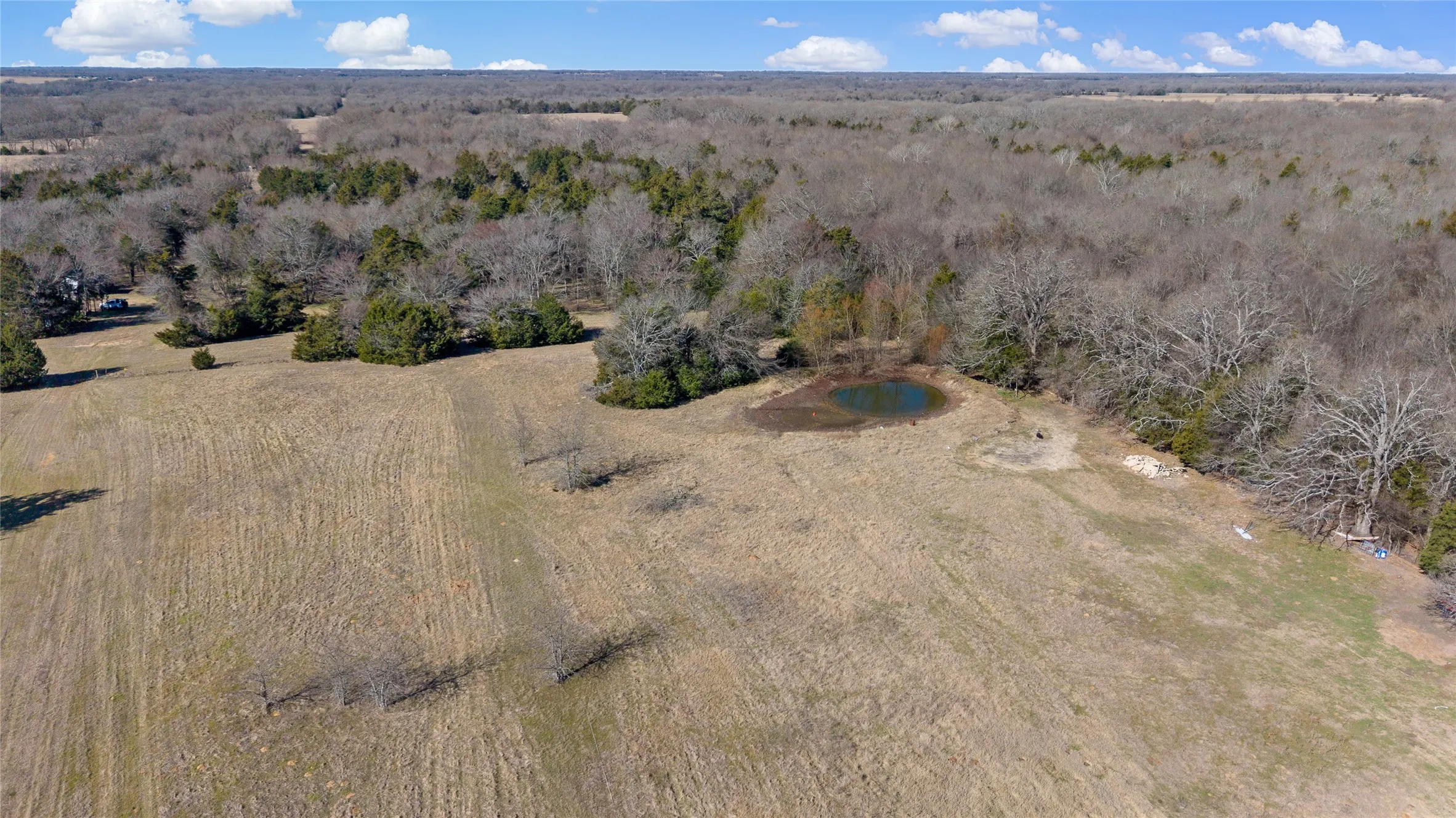 View of property location with a forest and rural landscape