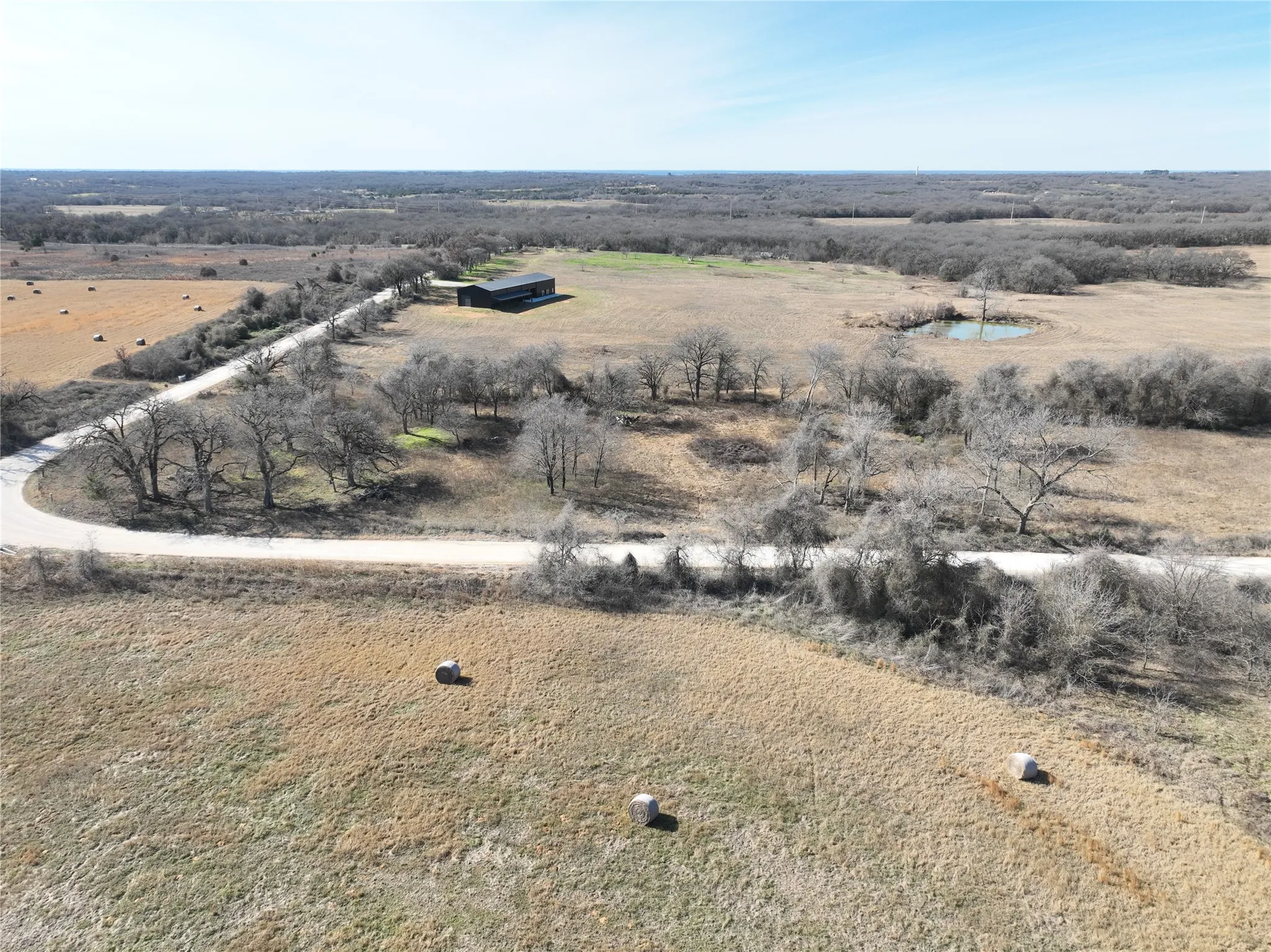 Aerial view of property and surrounding area featuring rural landscape