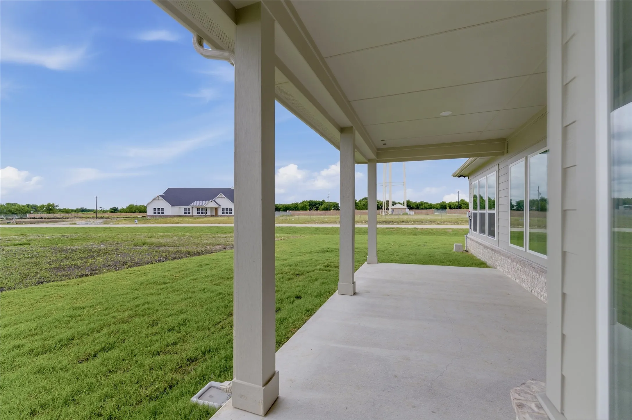 Covered patio with a concrete surface and architectural columns