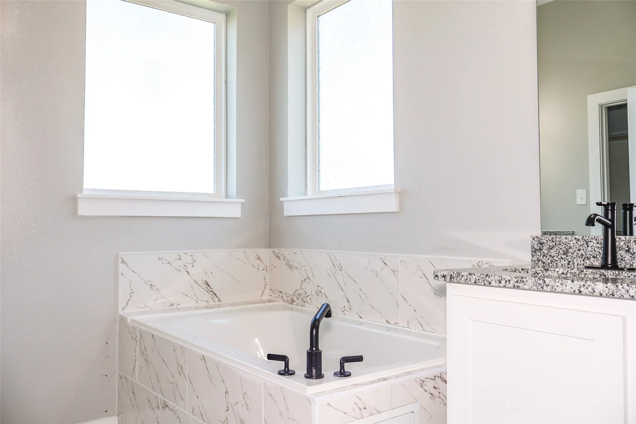 Full bathroom featuring a bath and vanity