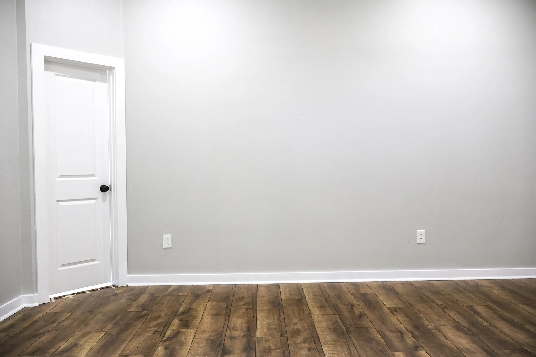 Unfurnished room featuring dark wood-type flooring
