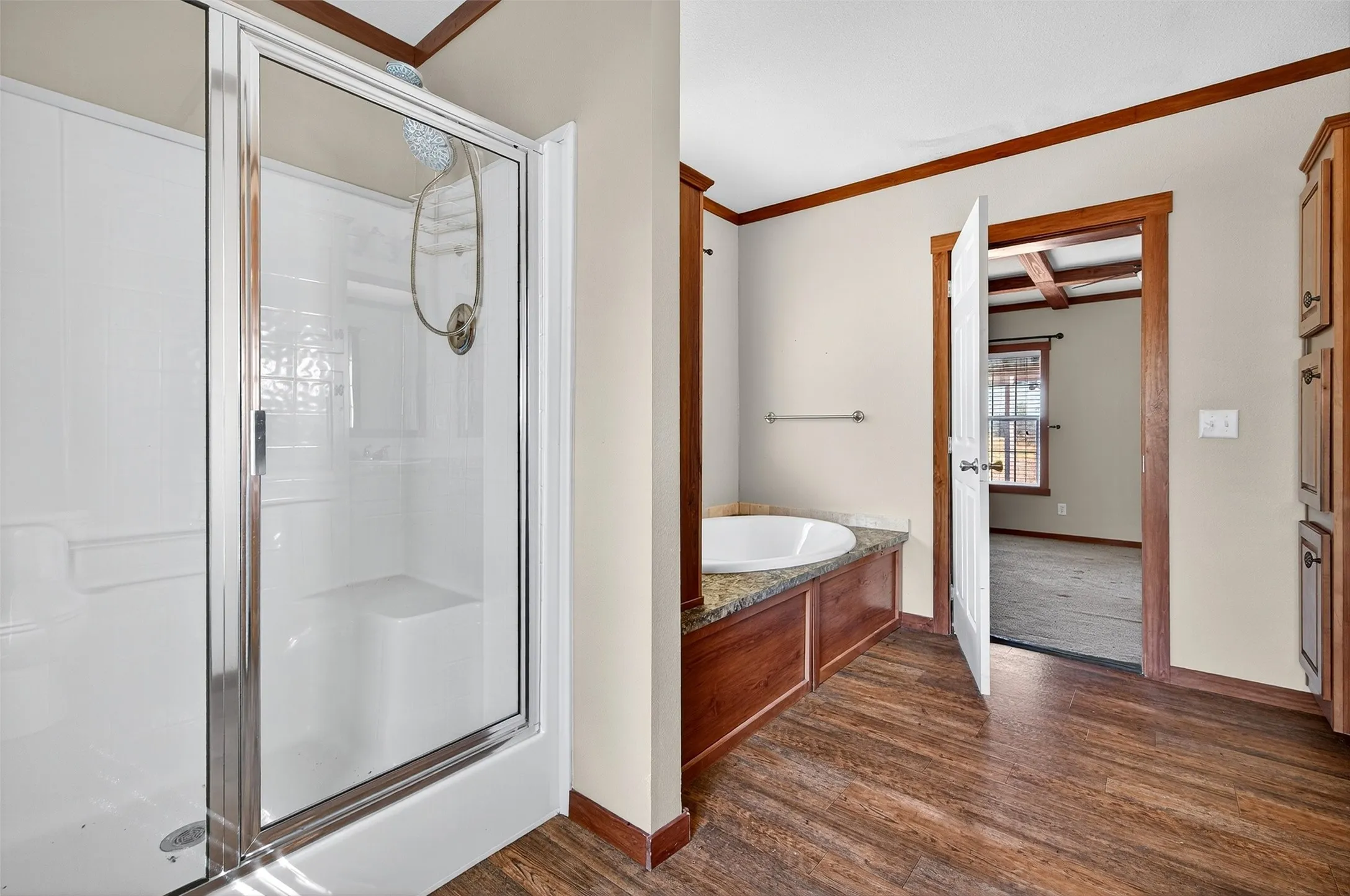 Full bath featuring a shower stall, a bath, dark wood finished floors, coffered ceiling, and beamed ceiling