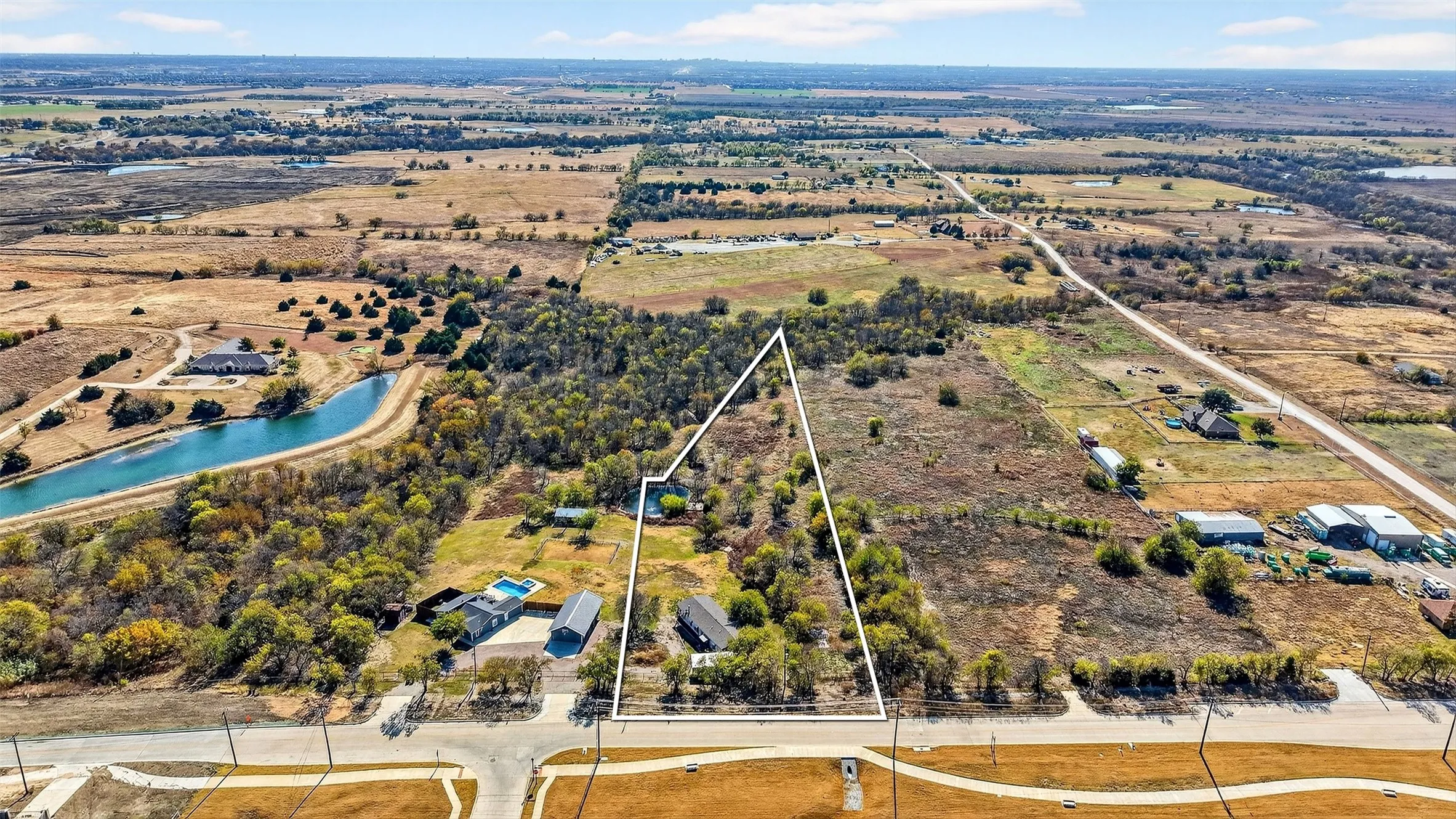 View of rural area with a nearby body of water and property boundaries highlighted