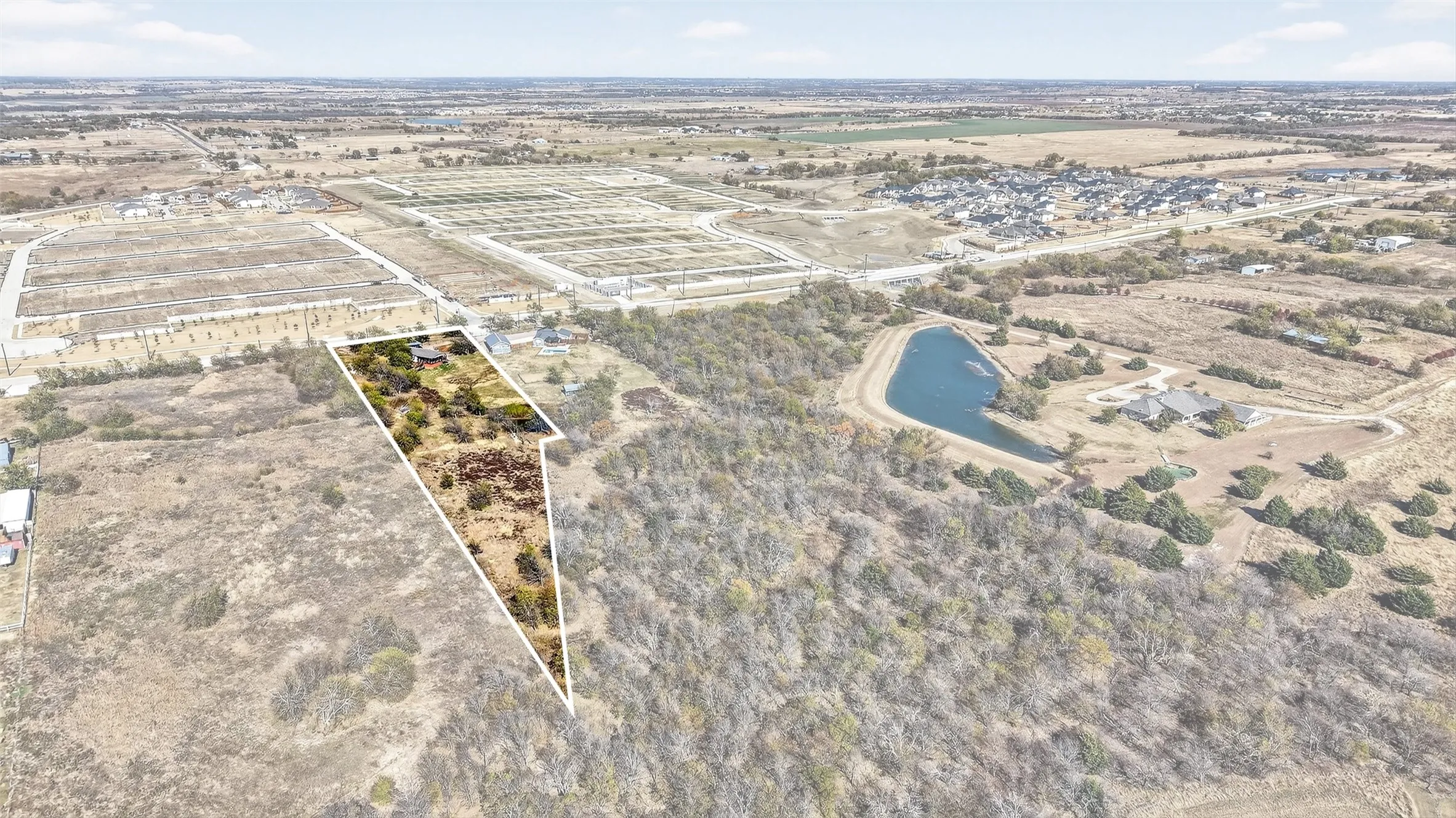 View of rural area with a nearby body of water and property boundaries highlighted