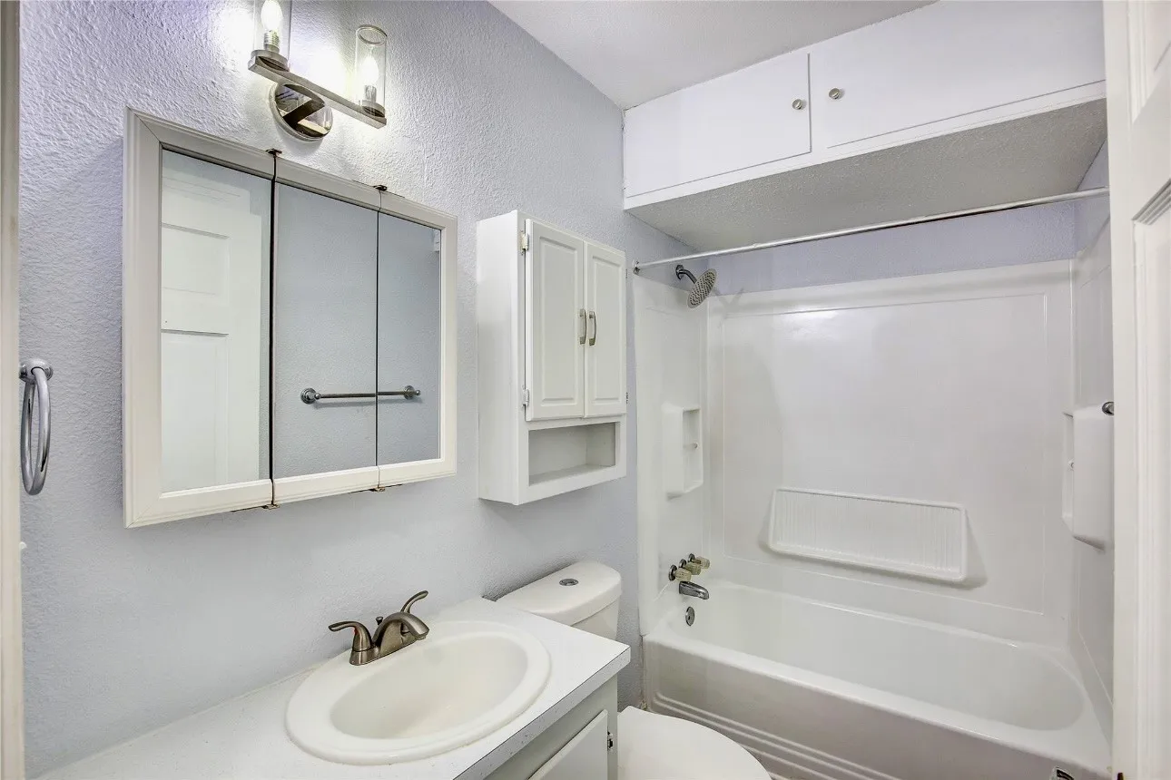 Full bathroom featuring bathing tub / shower combination, vanity, and toilet