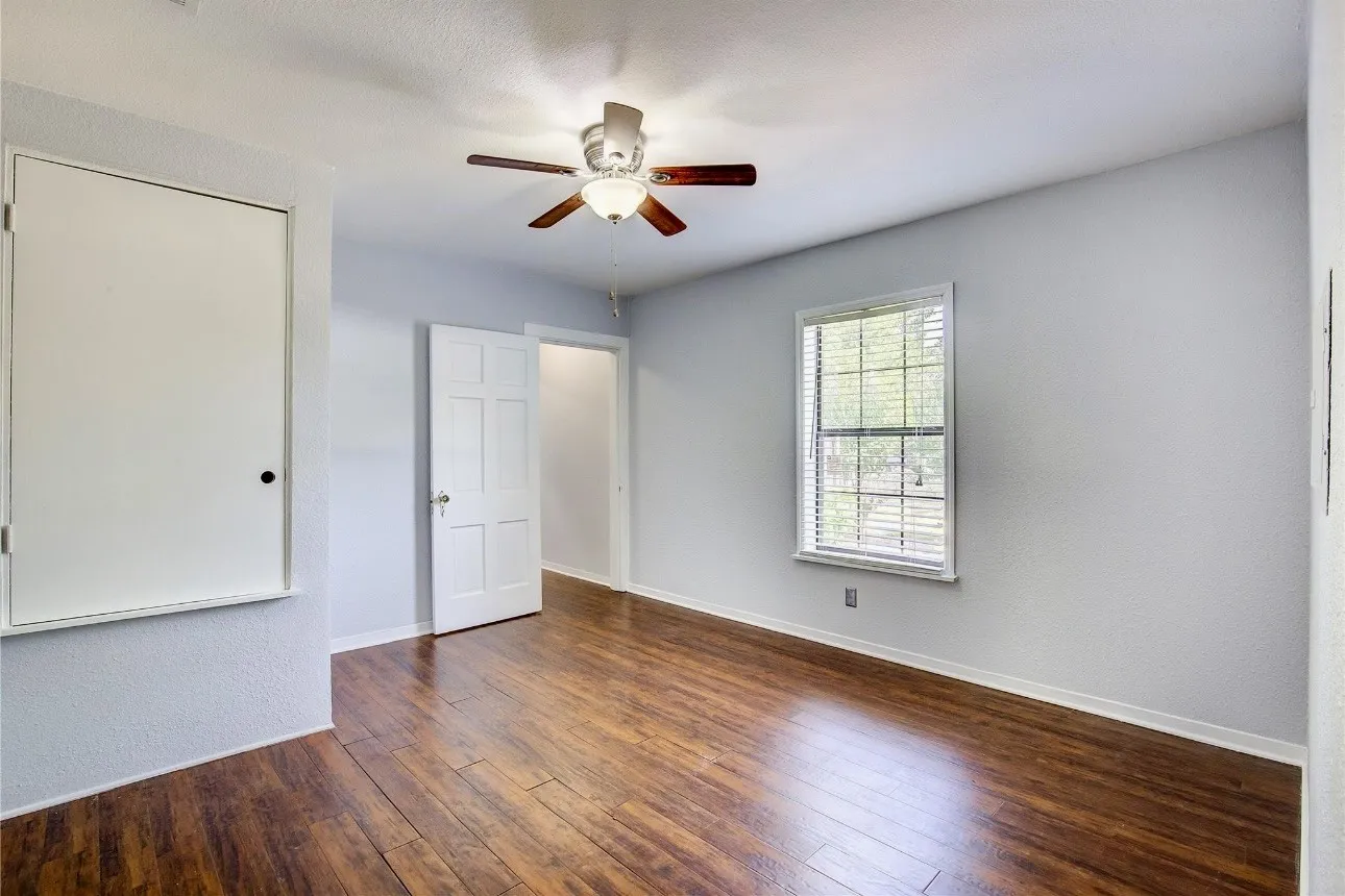 Spare room featuring dark hardwood / wood-style floors and ceiling fan