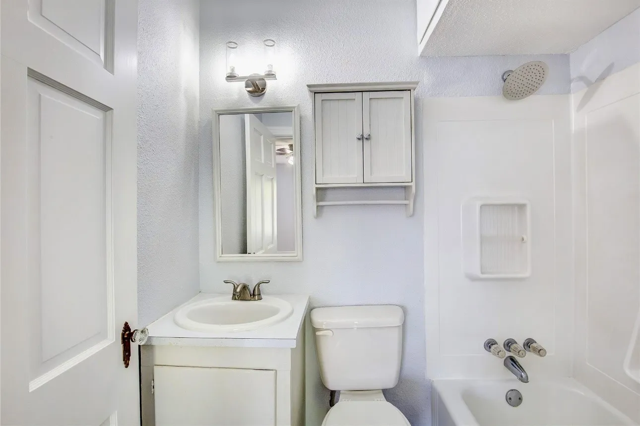Full bathroom with bathing tub / shower combination, vanity, and toilet