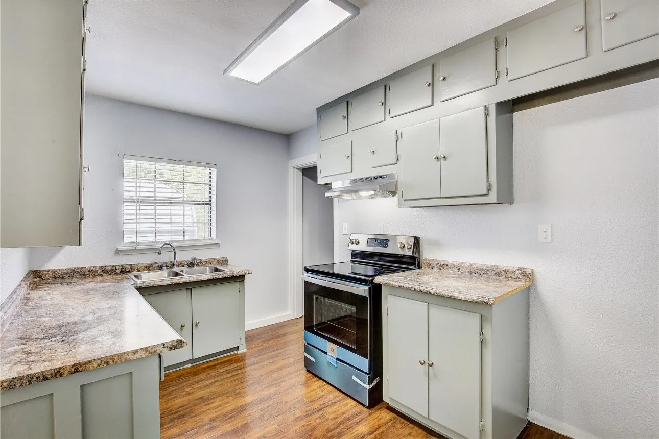Kitchen with gray cabinets, light hardwood / wood-style flooring, stainless steel electric range oven, and​​‌​​​​‌​​‌‌​‌‌​​​‌‌​‌​‌​‌​​​‌​​ sink